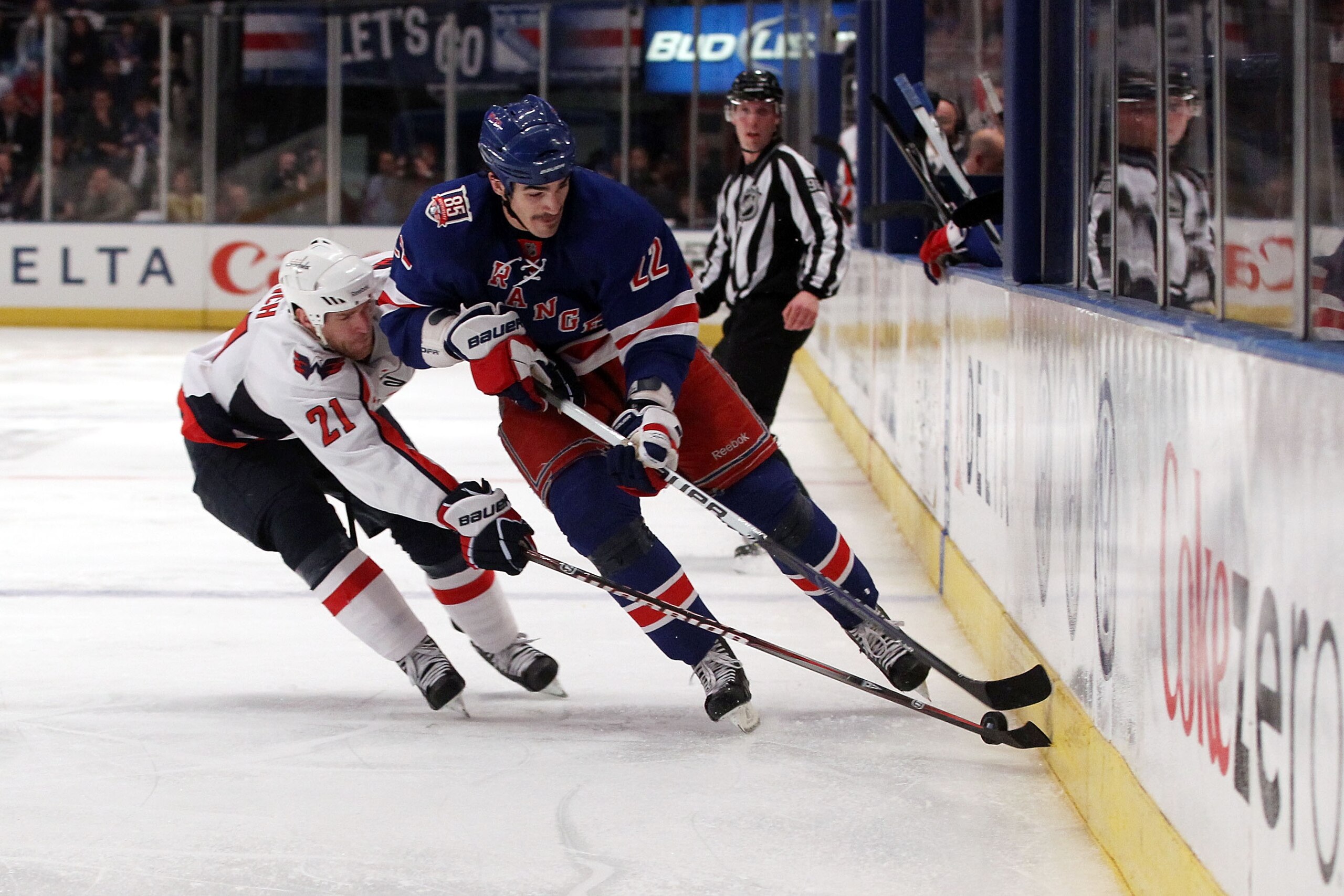 NEW YORK, NY - APRIL 20:  Brian Boyle #22 of the New York Rangers attempts to control the puck against Brooks Laich #21 of the Washington Capitals in Game Four of the Eastern Conference Quarterfinals during the 2011 NHL Stanley Cup Playoffs at Madison Squ