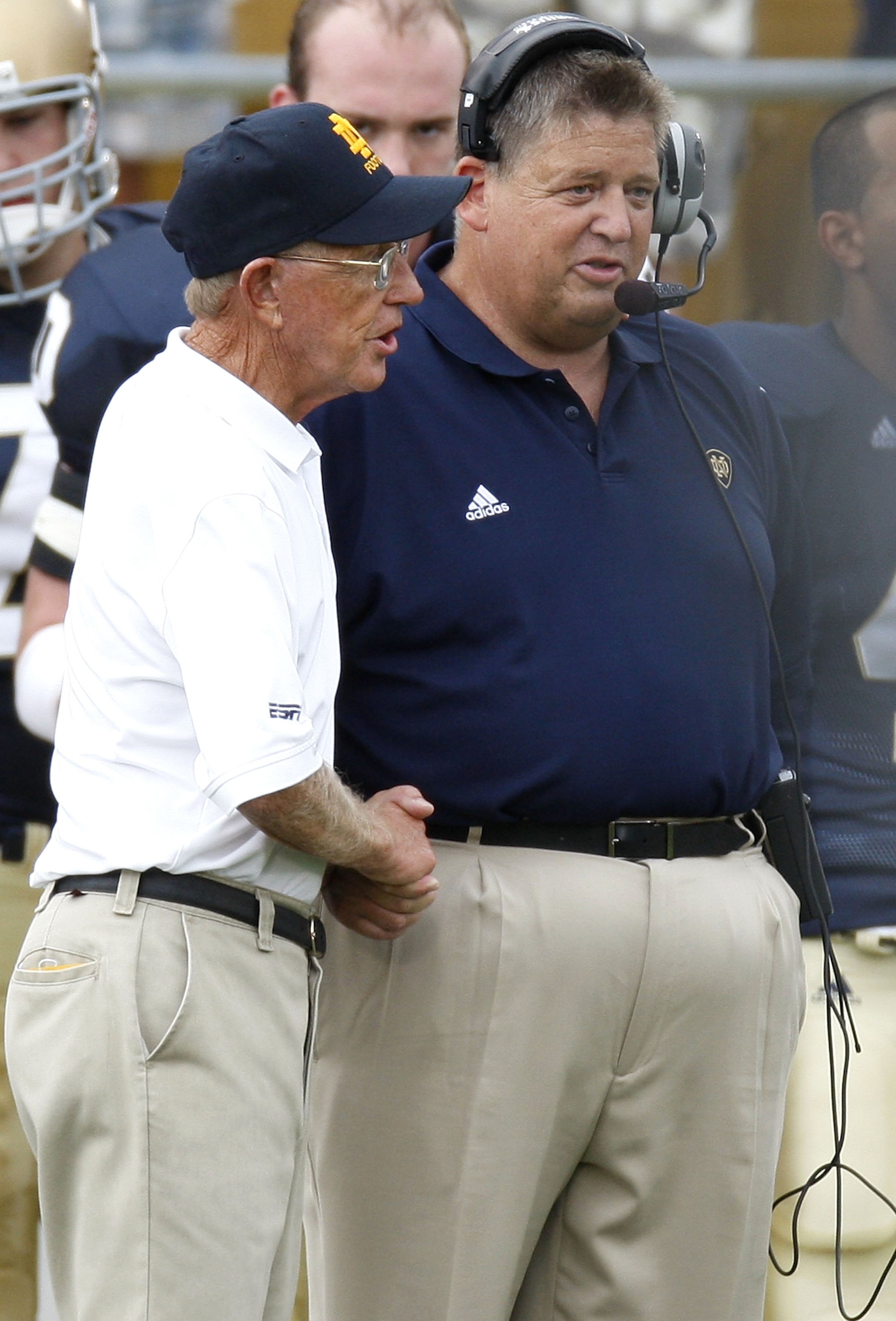 SOUTH BEND, IN - SEPTEMBER 13: Former head coach Lou Holtz of the Notre Dame Fighting Irish talks to current head coach Charlie Weis prior to playing the Michigan Wolverines on September 13, 2008 at Notre Dame Stadium in South Bend, Indiana.  (Photo by Gr