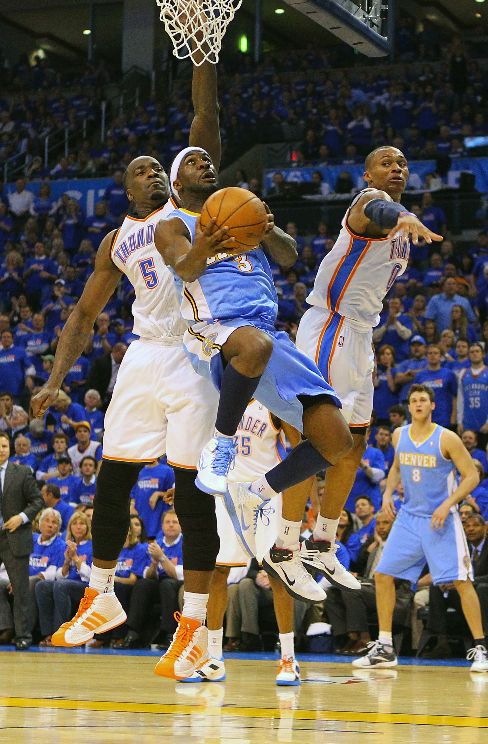 OKLAHOMA CITY, OK - APRIL 20: Ty Lawson #3 of the Denver Nuggets looks to score a basket against Kendrick Perkins #5 and Russell Westbrook #0 both of the Oklahoma City Thunder in Game Two of the Western Conference Quarterfinals in the 2011 NBA Playoffs on