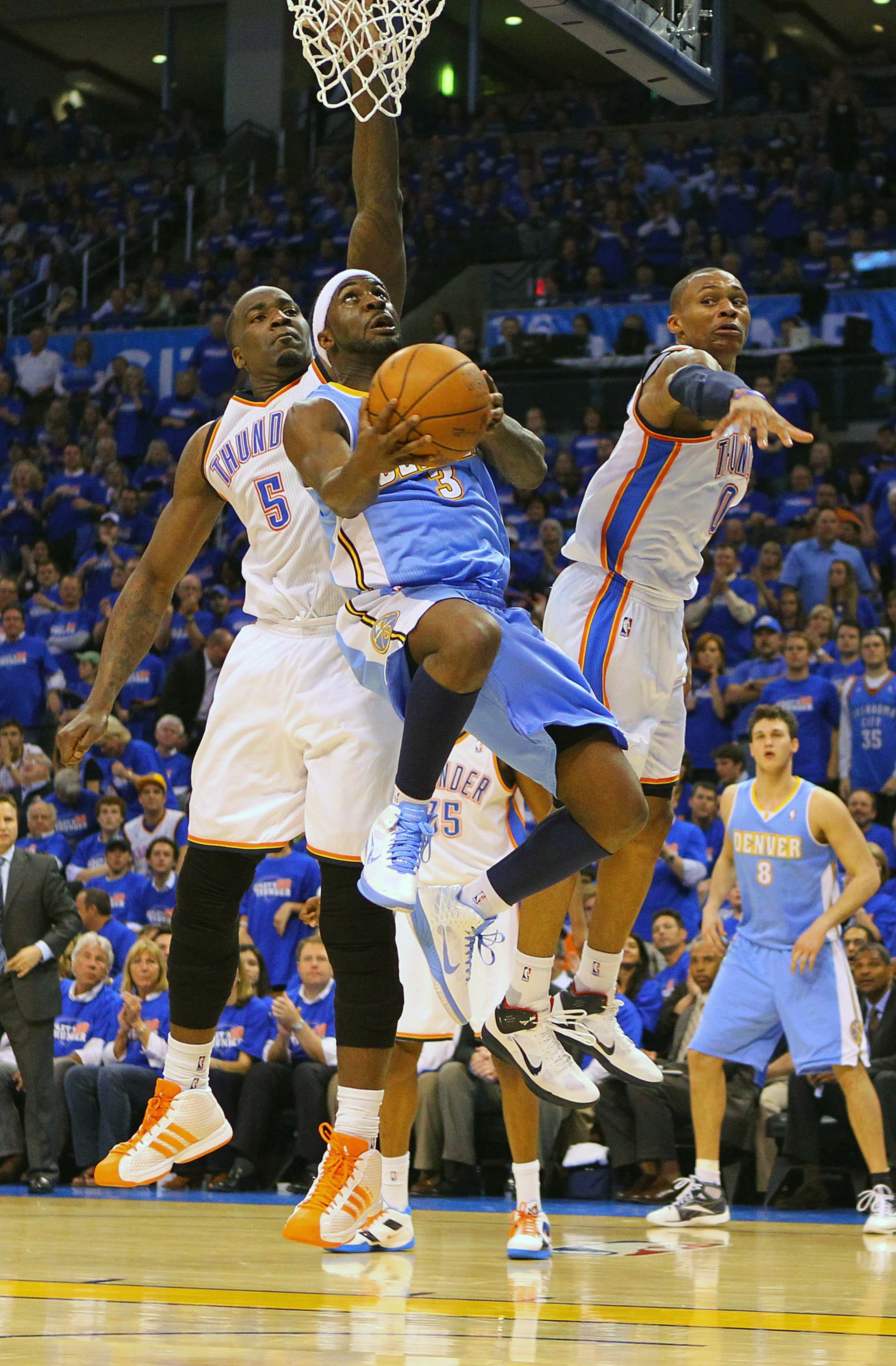 OKLAHOMA CITY, OK - APRIL 20: Ty Lawson #3 of the Denver Nuggets looks to score a basket against Kendrick Perkins #5 and Russell Westbrook #0 both of the Oklahoma City Thunder in Game Two of the Western Conference Quarterfinals in the 2011 NBA Playoffs on OKLAHOMA CITY, OK - APRIL 20: Ty Lawson #3 of the Denver Nuggets looks to score a basket against Kendrick Perkins #5 and Russell Westbrook #0 both of the Oklahoma City Thunder in Game Two of the Western Conference Quarterfinals in the 2011 NBA Playoffs on