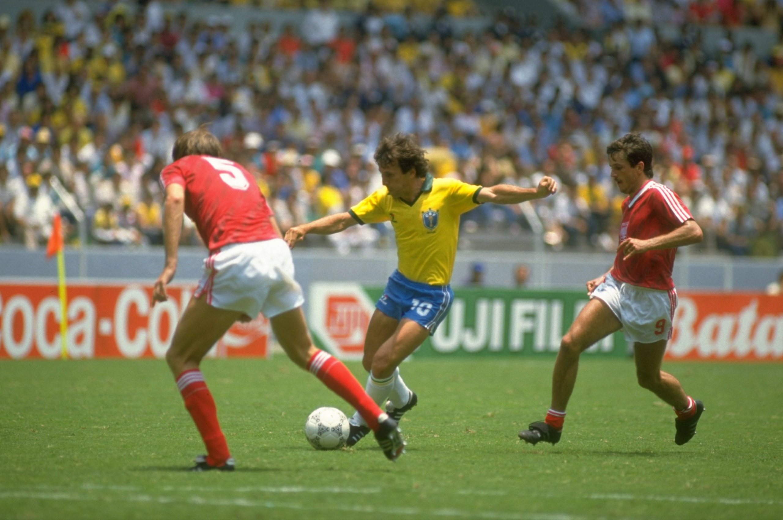 16 Jun 1986:  Zico (centre) of Brazil takes on Wojcicki (left) of Poland during the World Cup Second Round match at the Jalisco Stadium in Guadalajara, Mexico. Brazil won the match 4-0. \ Mandatory Credit: Allsport UK /Allsport