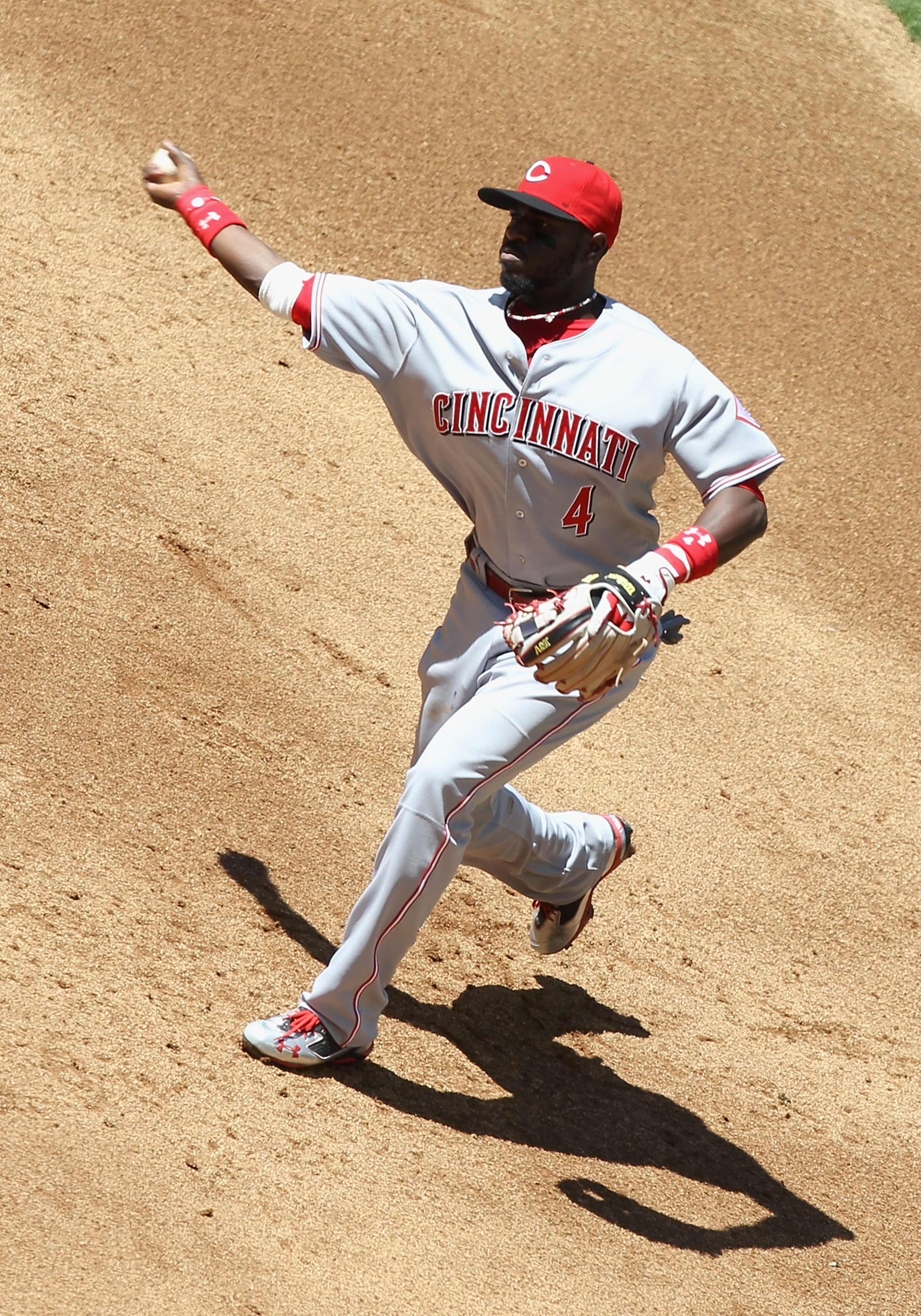 PHOENIX, AZ - APRIL 10:  Iniflder Brandon Phillips #4 of the Cincinnati Reds fields a ground ball out against the Arizona Diamondbacks during the Major League Baseball game at Chase Field on April 10, 2011 in Phoenix, Arizona.  The Diamondbacks defeated t