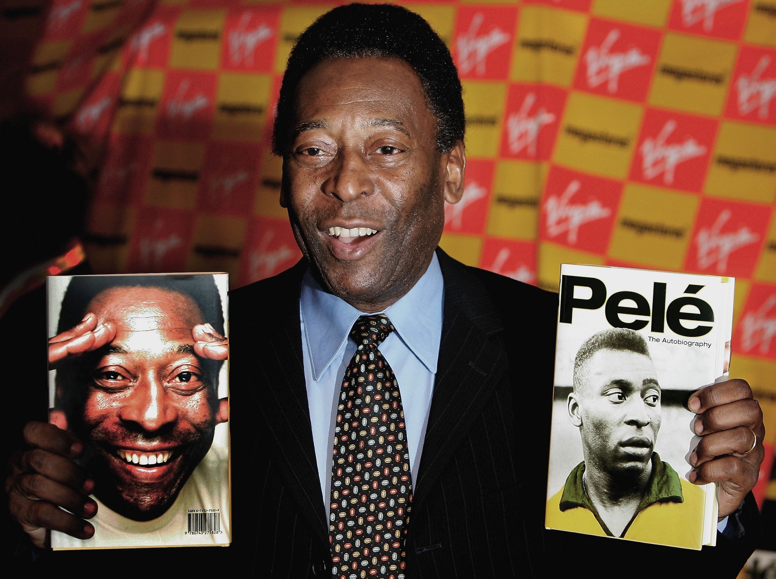 LONDON - MAY 18:  Brazilian football hero Pele holds copies of his autobiography at a book launch at the Virgin Megastore Picadilly on May 18, 2006 in London, England. The man they also call Edson Arantes do Nascimento attended the launch signing copies o