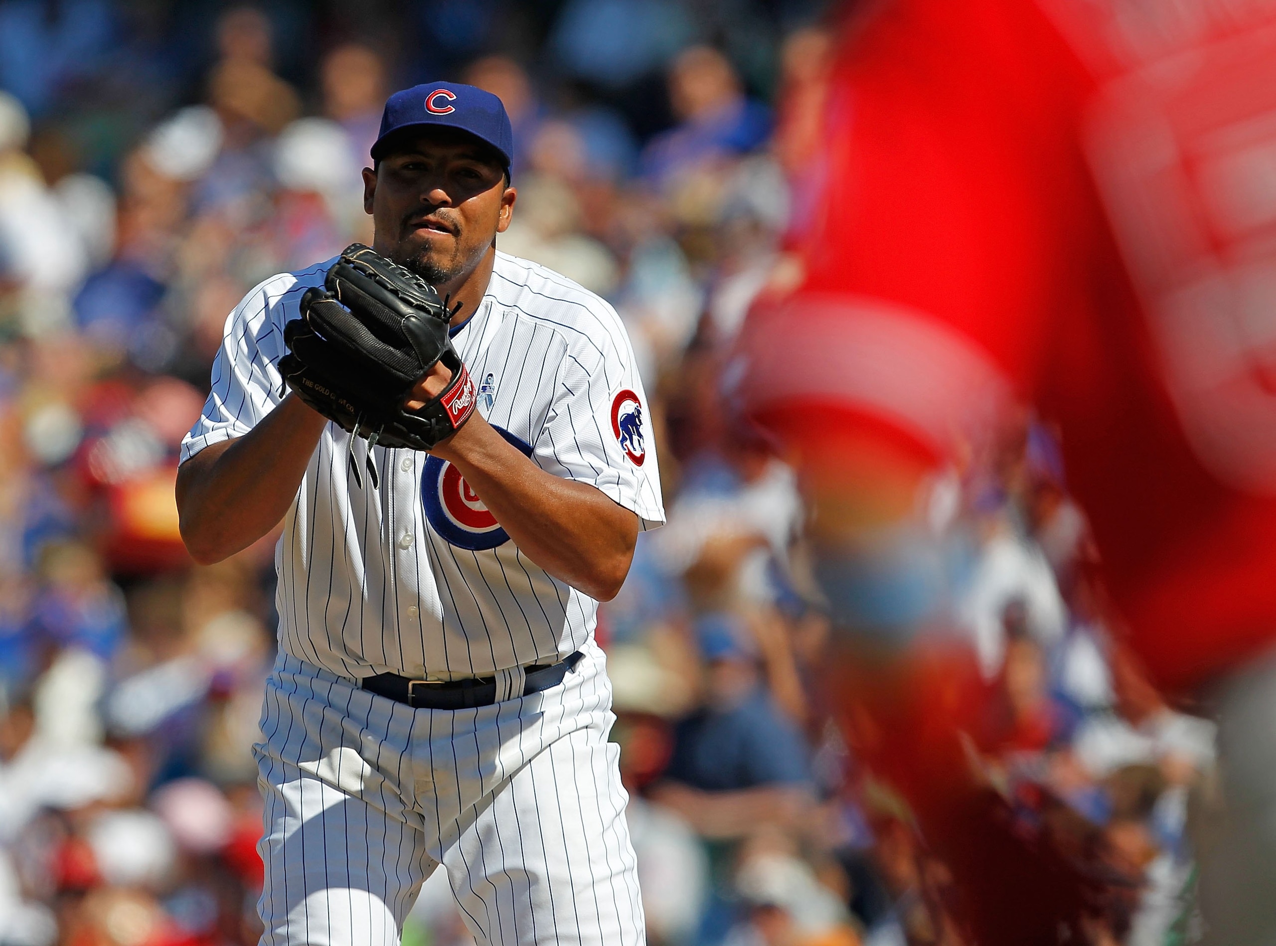 CHICAGO - JUNE 20: Carlos Zambrano #38 of the Chicago Cubs looks at a runner from the Los Angeles Angels of Anaheim at third base before pitching at Wrigley Field on June 20, 2010 in Chicago, Illinois. The Cubs defeated the Angels 12-1. (Photo by Jonathan