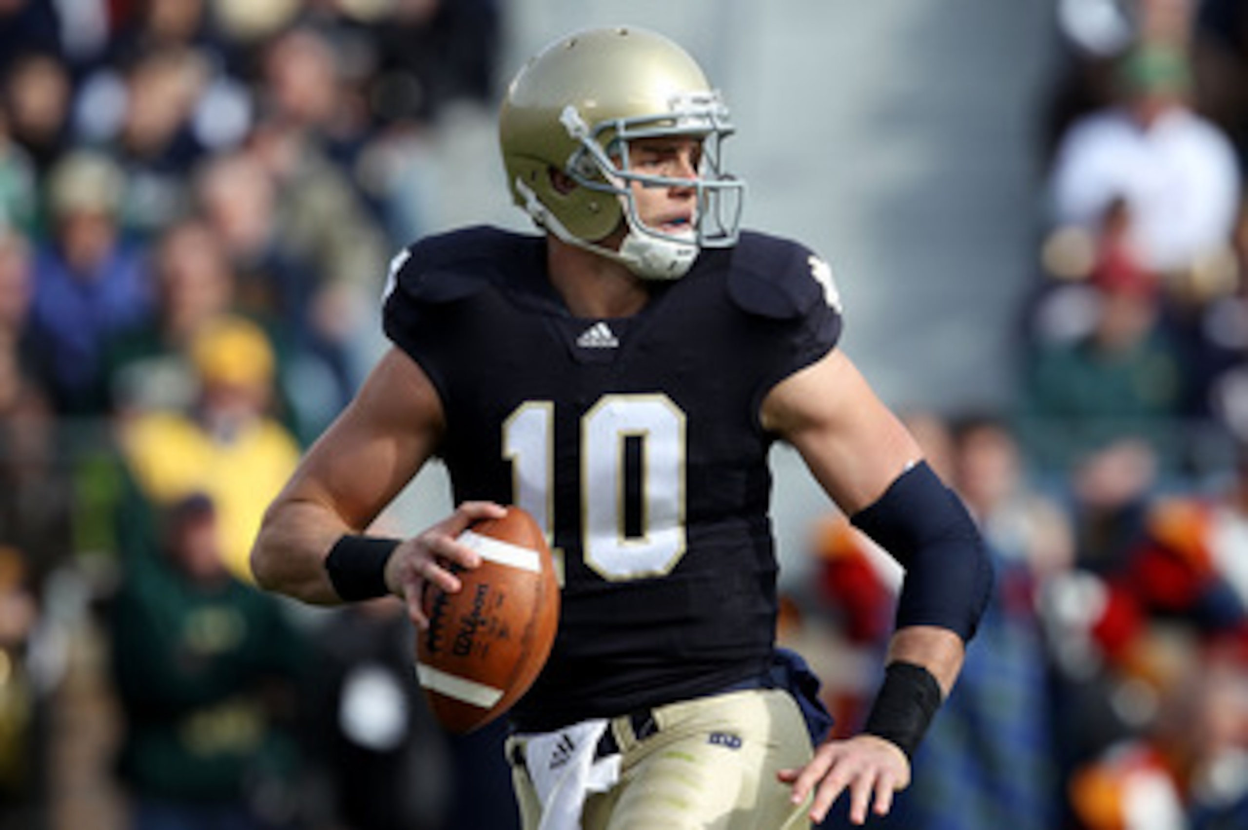 SOUTH BEND, IN - OCTOBER 30: Dayne Crist #10 of the Notre Dame Fighting Irish looks for a receiver against the Tulsa Golden Hurricane at Notre Dame Stadium on October 30, 2010 in South Bend, Indiana. Tulsa defeated Notre Dame 28-27. (Photo by Jonathan Dan