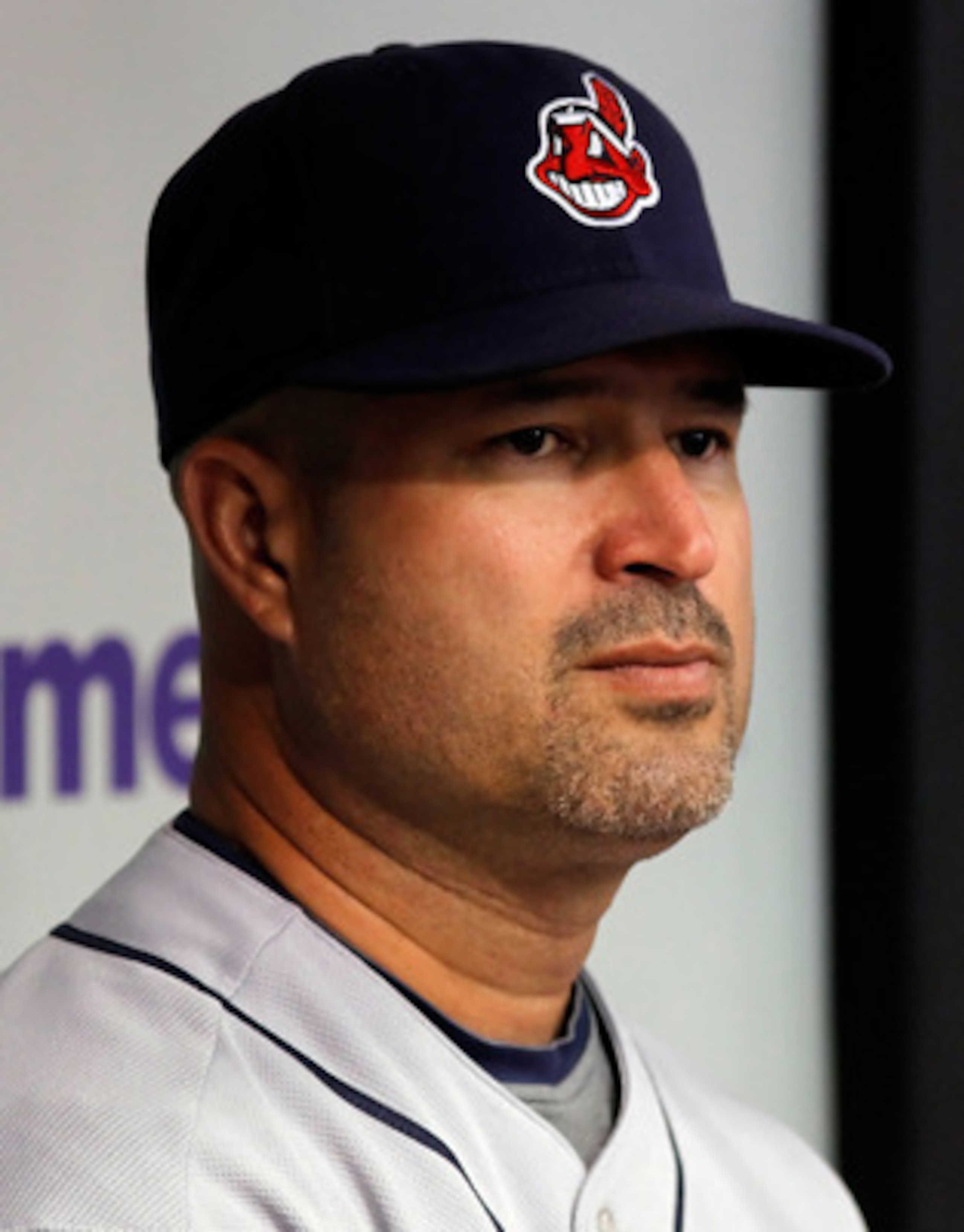 ST. PETERSBURG - JULY 11:  Manager Manny Acta #11 of the Cleveland Indians watches his team from the dugout against the Tampa Bay Rays at Tropicana Field on July 11, 2010 in St. Petersburg, Florida.  (Photo by J. Meric/Getty Images)