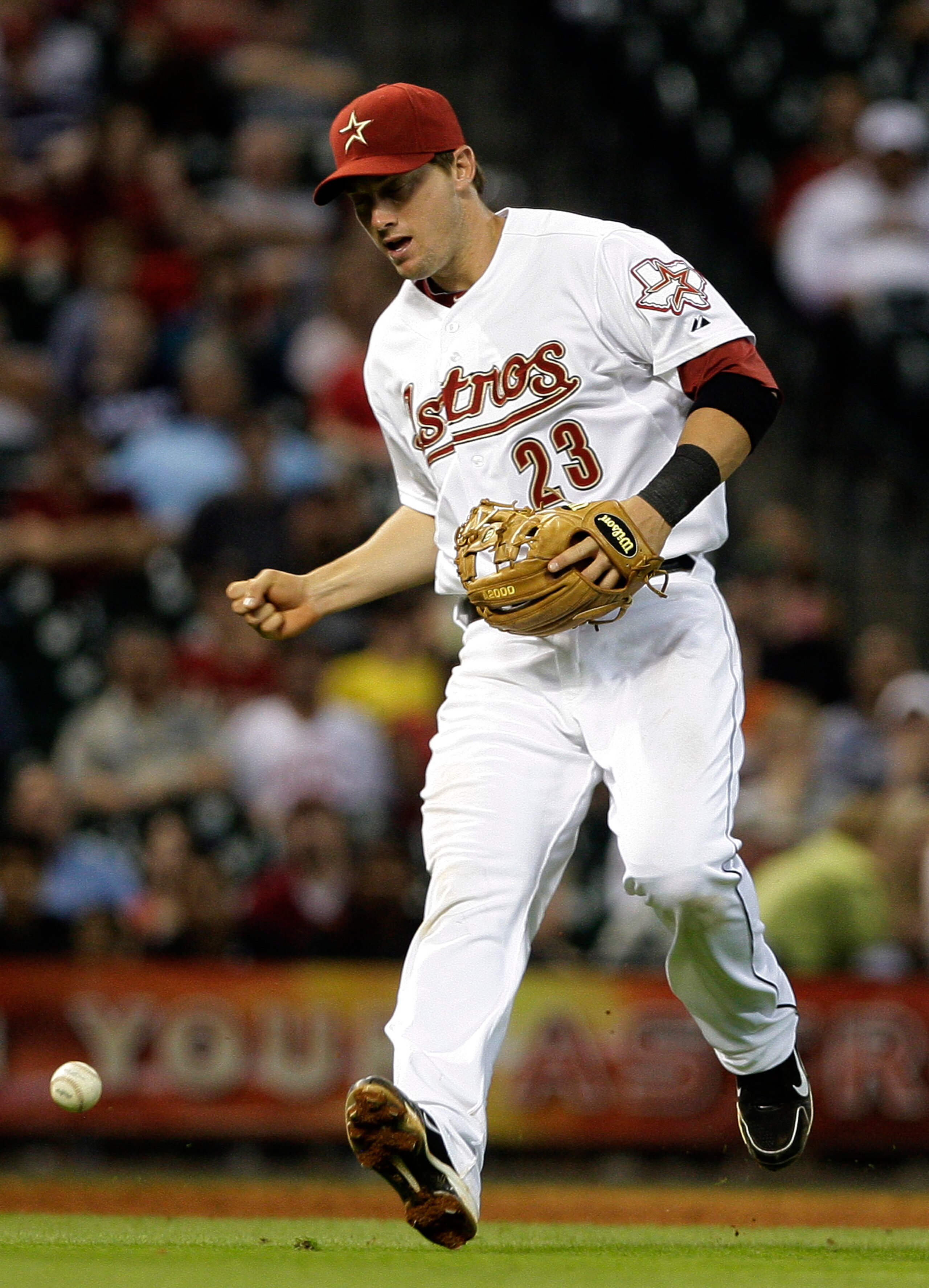 HOUSTON,TX- APRIL 9 : Third baseman Chris Johnson #23 of the Houston Astros makes an error on a broken bat single by Gaby Sanchez #15 of the Florida Marlins in the seventh inning in a MLB  baseball game on April 9, 2011 at Minute Maid Park in Houston, Tex