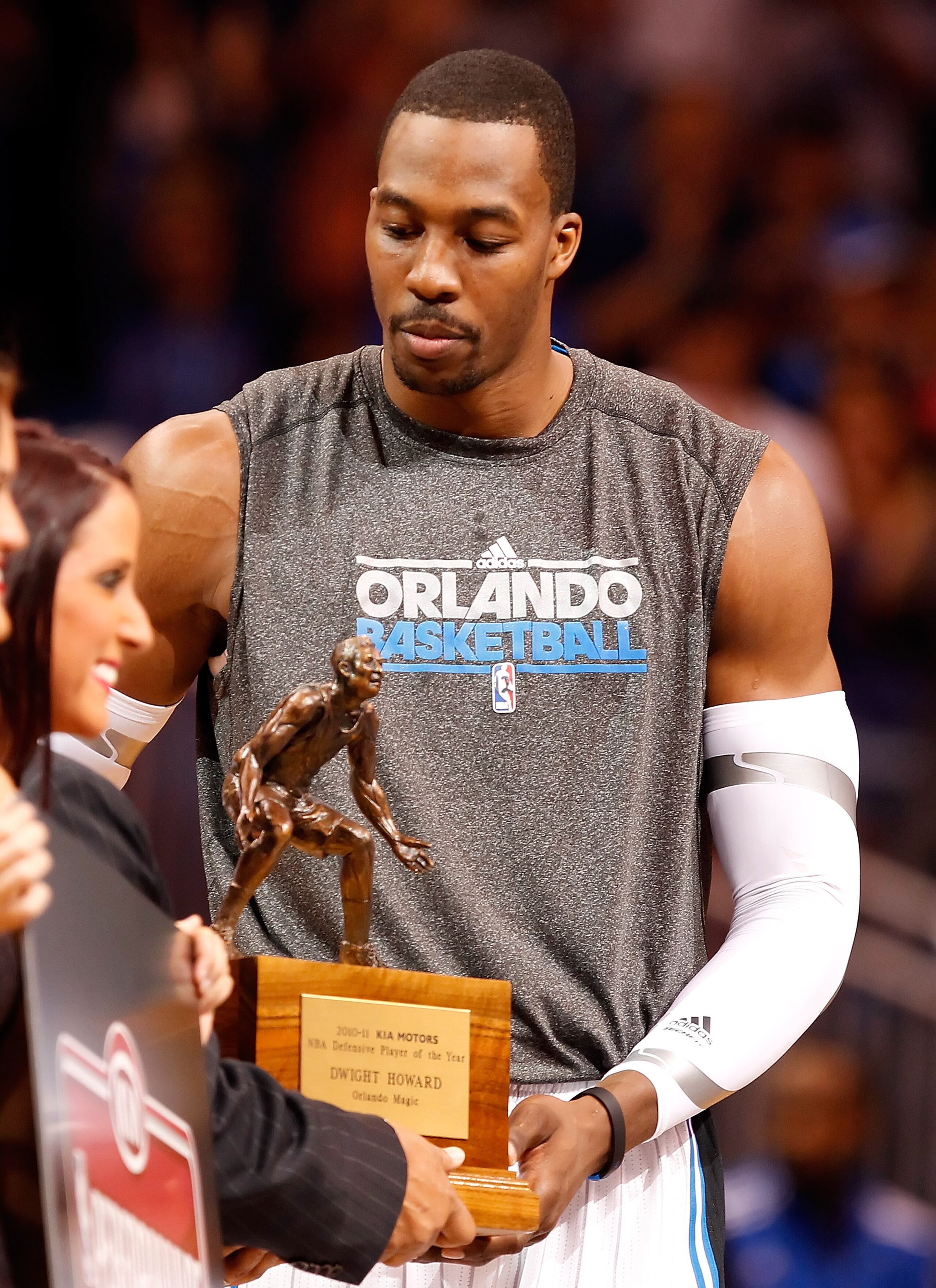 ORLANDO, FL - APRIL 19:  Dwight Howard #12 of the Orlando Magic receives his Defensive Player of the Year award just before the start of Game Two of the Eastern Conference Quarterfinals of the 2011 NBA Playoffs against the Atlanta Hawks on April 19, 2011