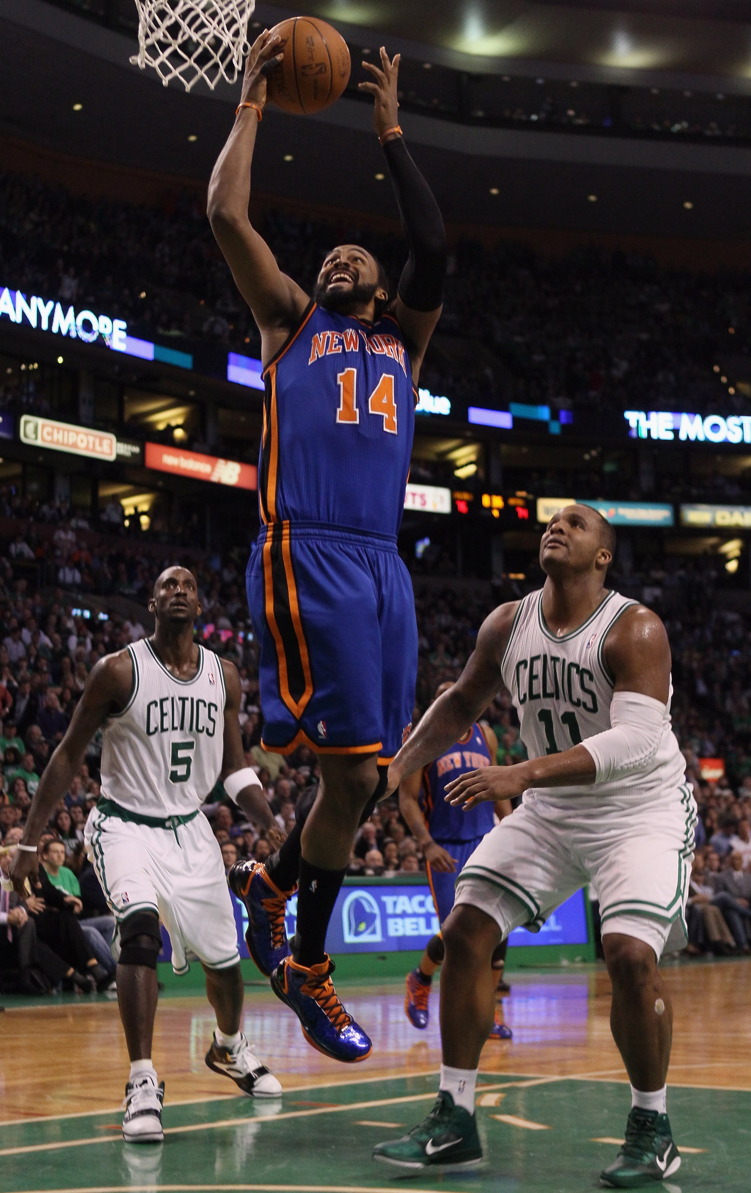 BOSTON, MA - APRIL 19:  Ronny Turiaf #14 of the New York Knicks takes a shot as Kevin Garnett #5 and Glen Davis #11 of the Boston Celtics defend in Game Two of the Eastern Conference Quarterfinals in the 2011 NBA Playoffs on April 19, 2011 at the TD Garde