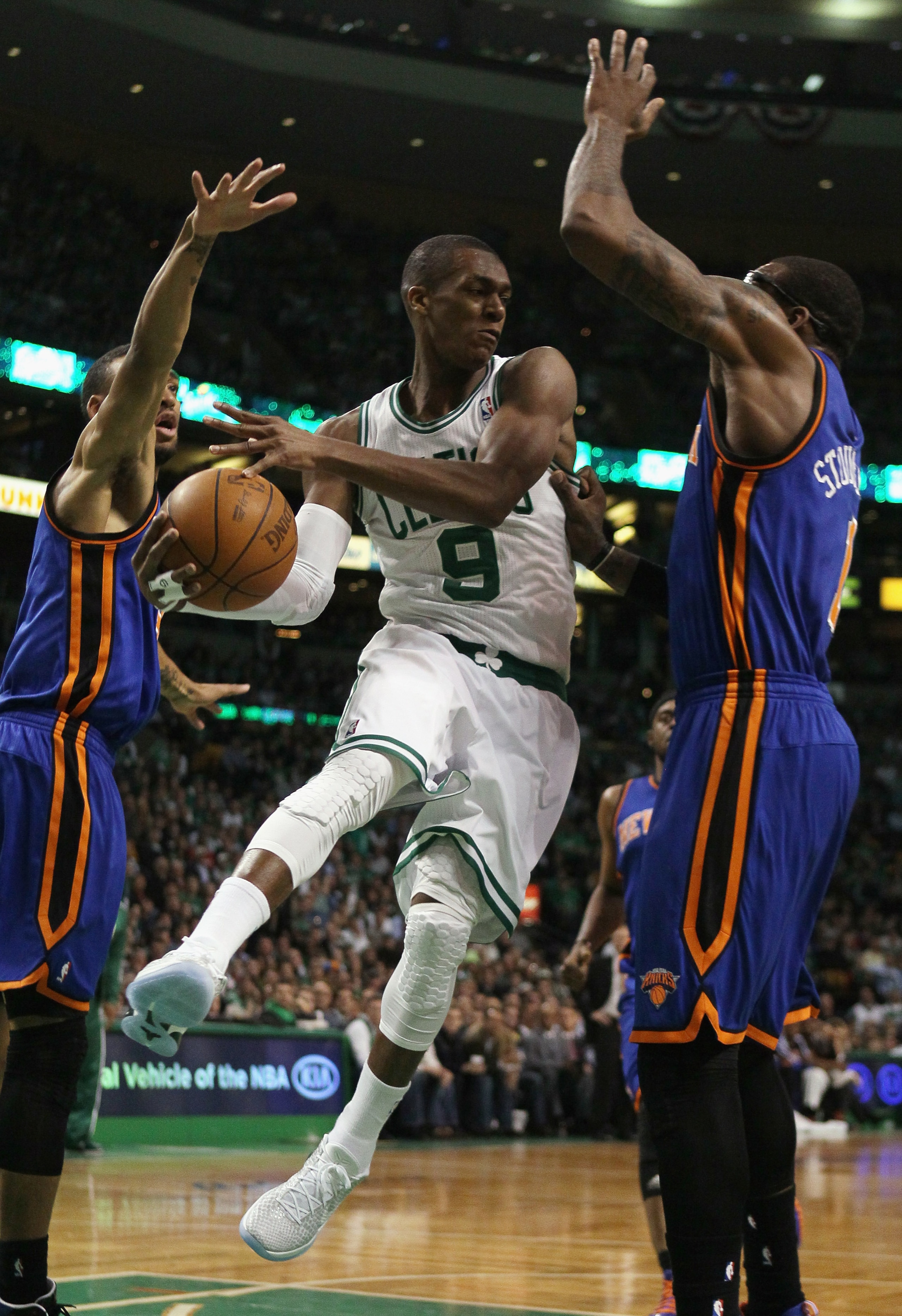 BOSTON, MA - APRIL 19:  Rajon Rondo #9 of the Boston Celtics looks to pass as Amare Stoudemire #1 and Toney Douglas #23 of the New York Knicks defend in Game Two of the Eastern Conference Quarterfinals in the 2011 NBA Playoffs on April 19, 2011 at the TD