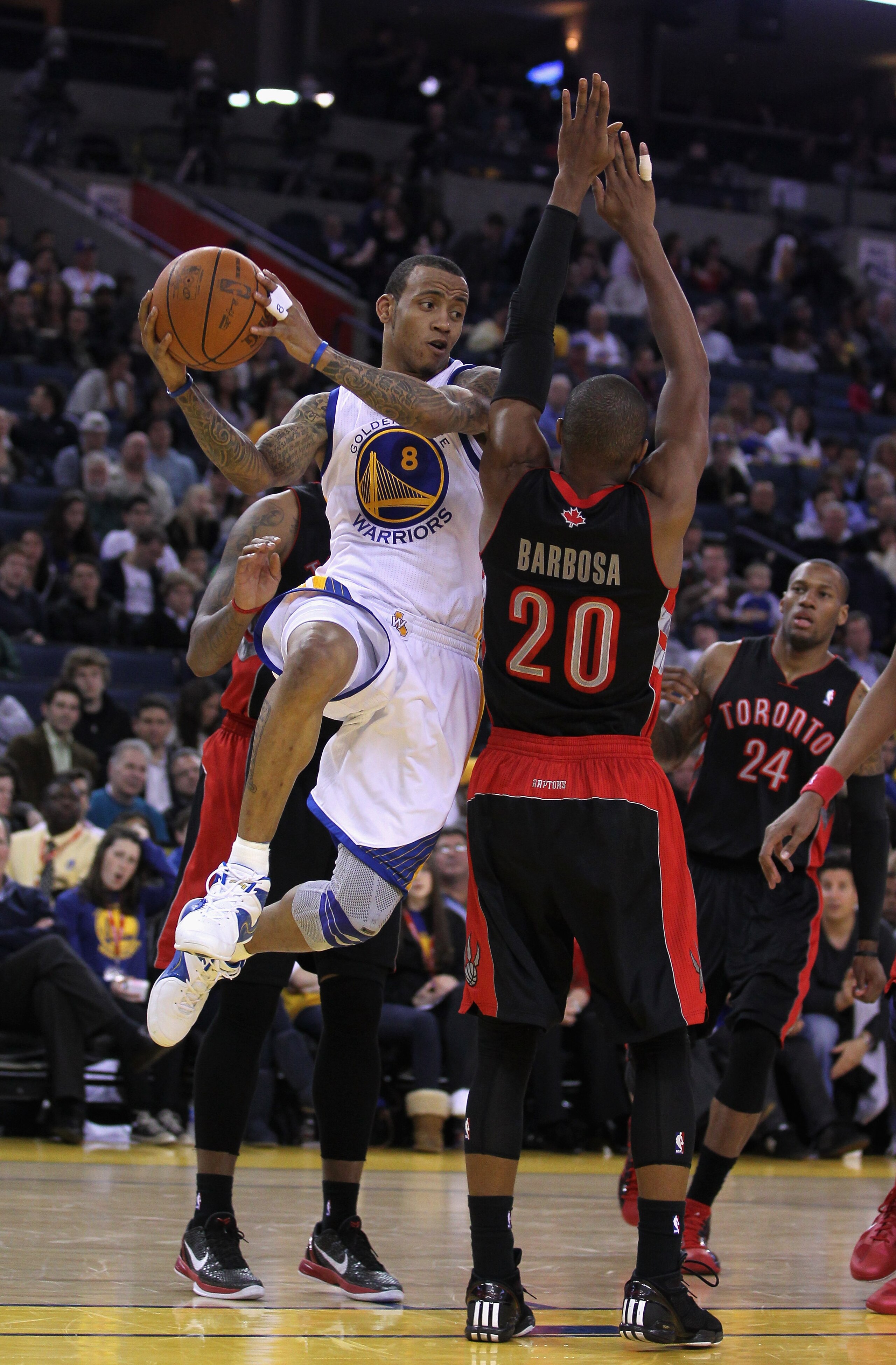 OAKLAND, CA - MARCH 25: Monta Ellis #8 of the Golden State Warriors drives around Leandro Barbosa #20 of the Toronto Raptors at Oracle Arena on March 25, 2011 in Oakland, California. NOTE TO USER: User expressly acknowledges and agrees that, by downloadin