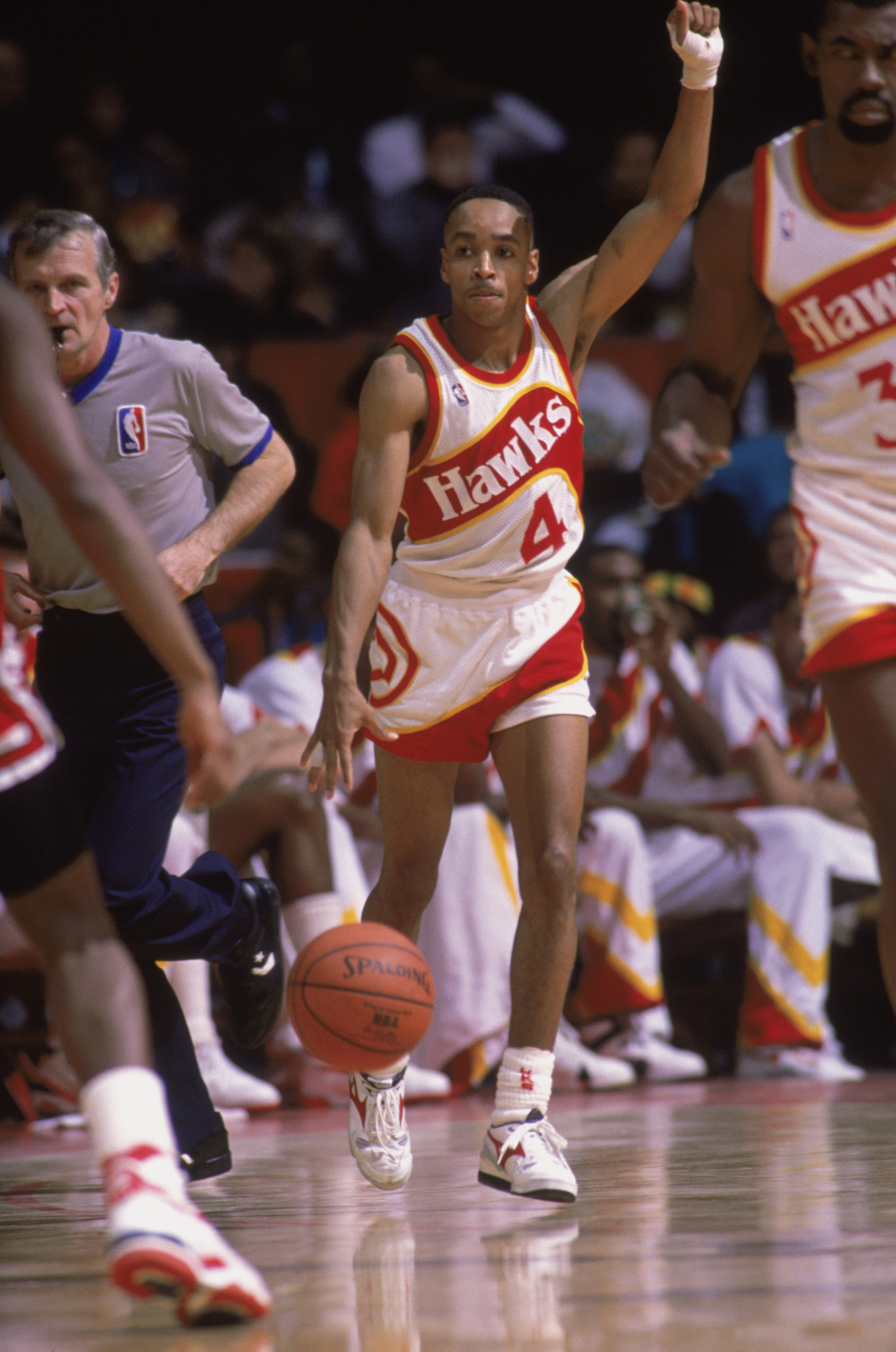CHICAGO - 1989:  Spud Webb #4 of the Atlanta Hawks dribbles the ball during a NBA game against the Chicago Bulls at Chicago Stadium in Chicago, Illinois in 1989.  (Photo by Rick Stewart/Getty Images)
