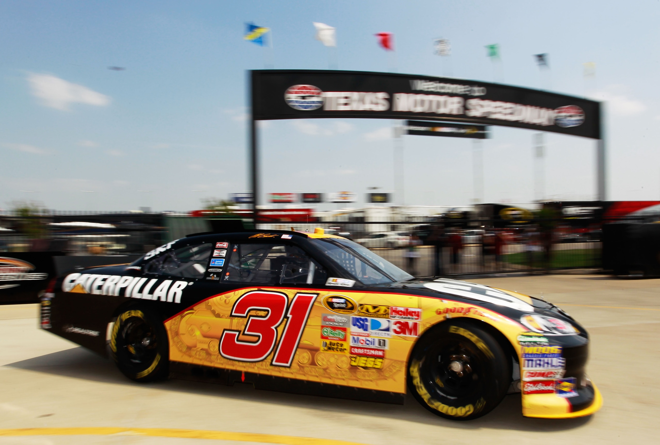 FORT WORTH, TX - APRIL 08:  Jeff Burton drives the #31 Caterpillar Chevrolet through the garage area during practice for the NASCAR Sprint Cup Series Samsung Mobile 500 at Texas Motor Speedway on April 8, 2011 in Fort Worth, Texas.  (Photo by Tom Penningt