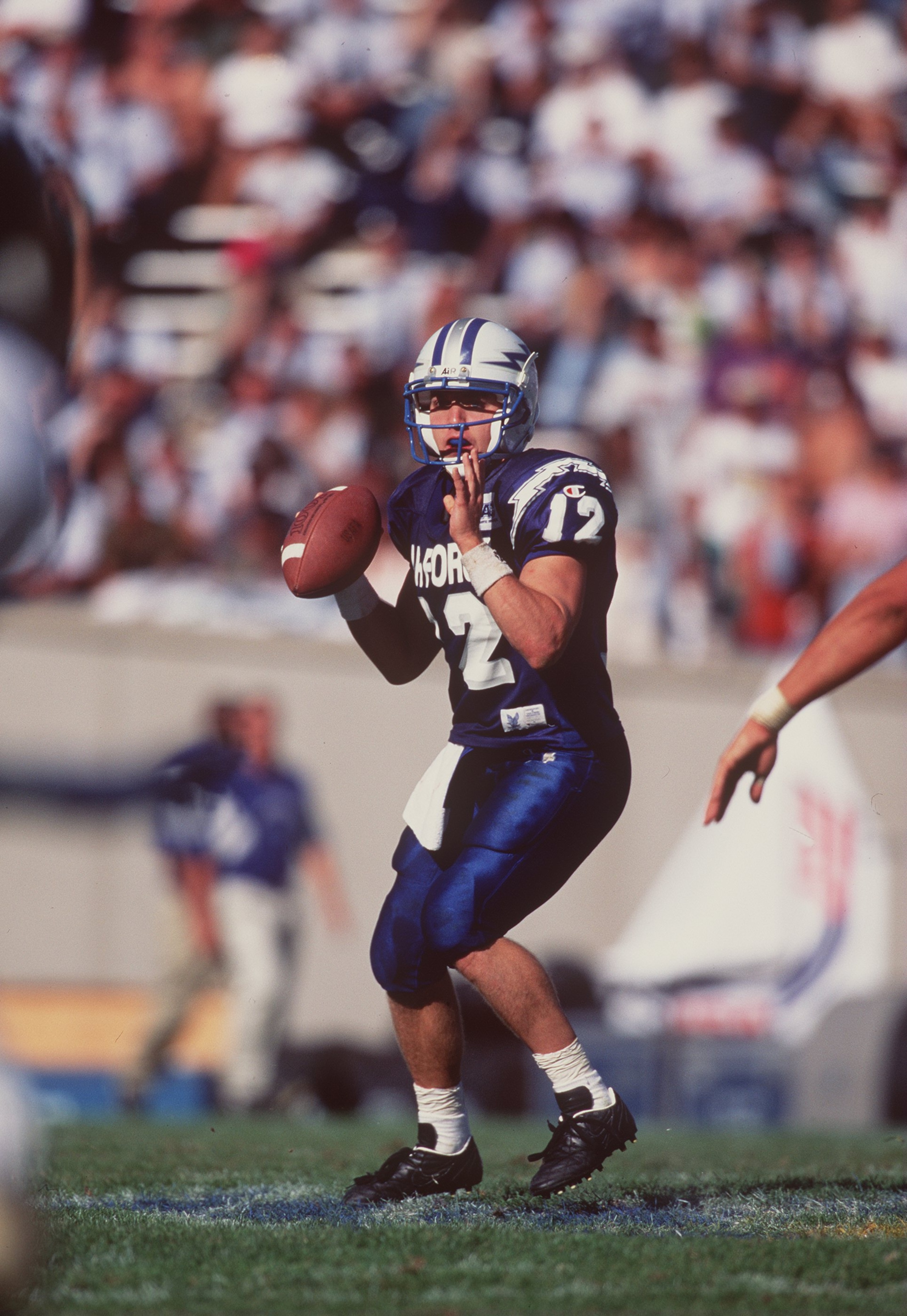 16 Sep 1995:  Quarterback Beau Morgan #12 of the Air Force Falcons looks down field for an open receiver as he sets his feet to throw the ball during a play in the Falcons 27-20 loss to the Colorado State Rams at Falcon Stadium in Colorado Springs, Colora