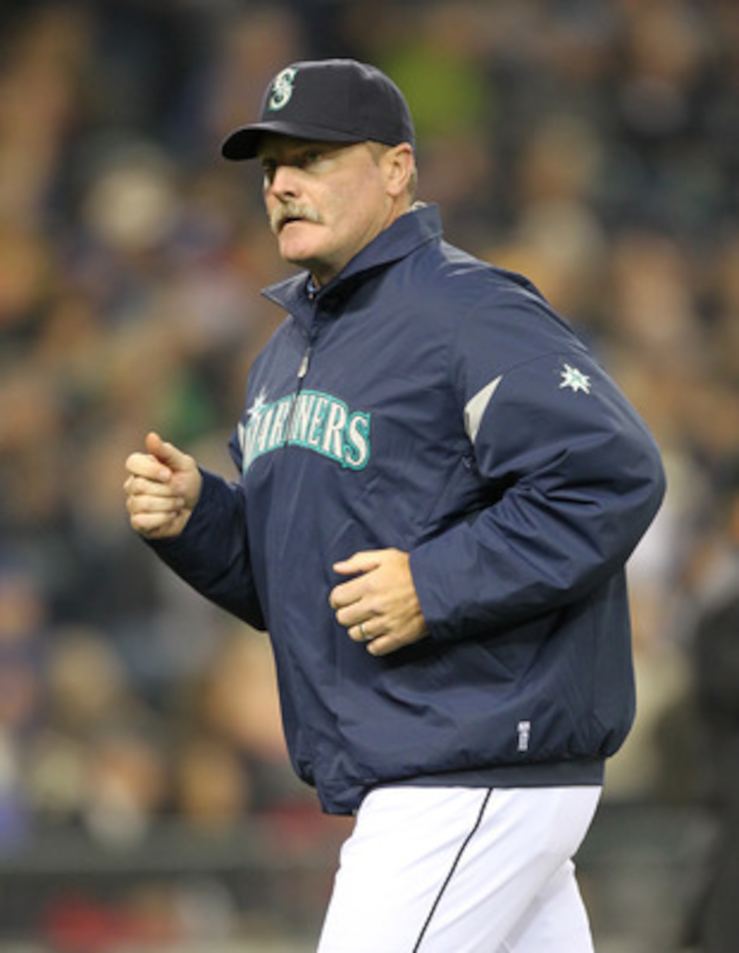 SEATTLE, WA - APRIL 08:  Manager Eric Wedge #22 of the Seattle Mariners heads back to the dugout after a visit to the mound against the Cleveland Indians during the Mariners' home opener at Safeco Field on April 8, 2011 in Seattle, Washington. (Photo by O