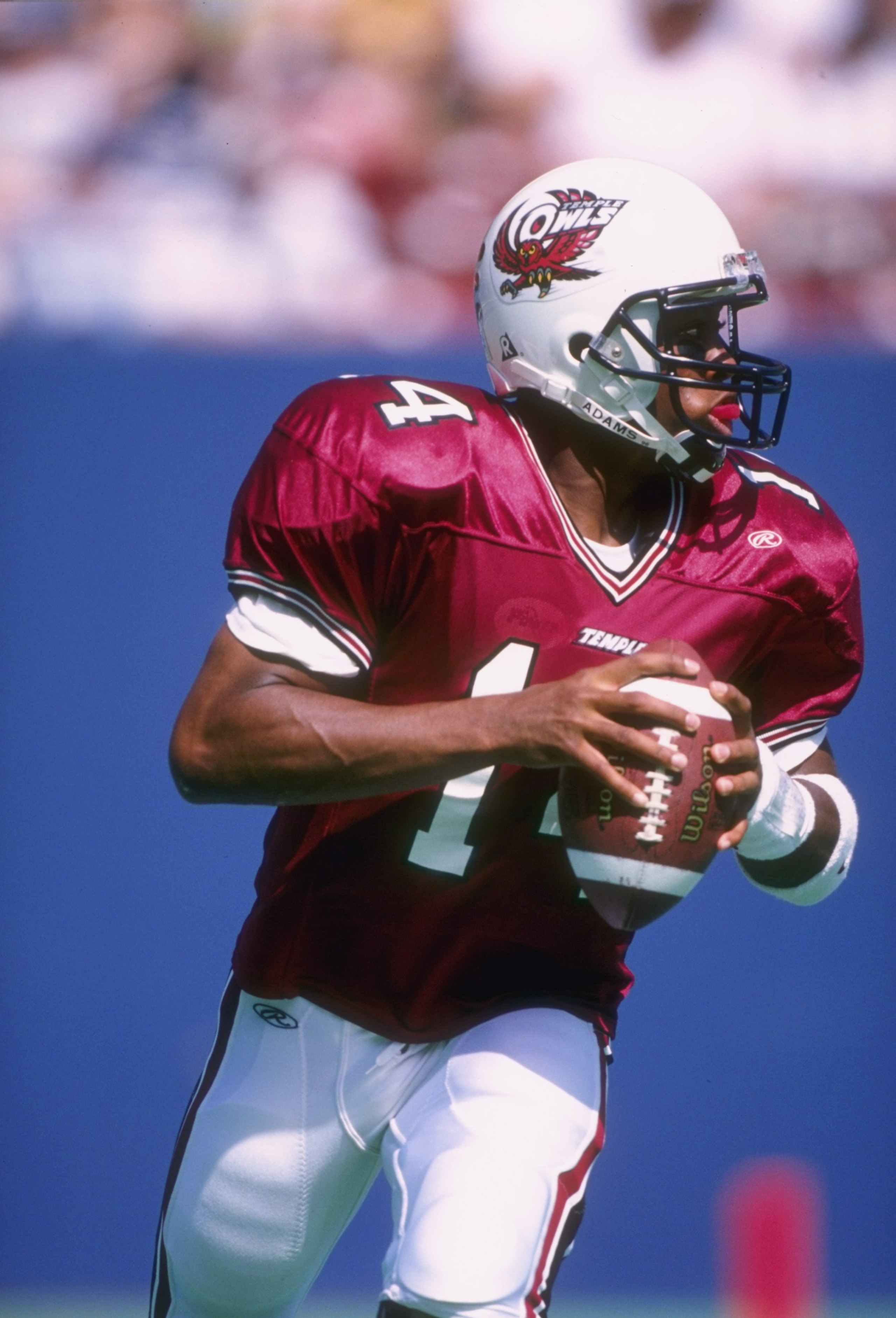 21 Sep 1996:  Quarterback Henry Burris of the Temple Owls rolls out of the pocket as he looks down field for an open receiver while scanning the defense during a pass play in the Owls 41-0 loss to the Penn State Nittany Lions at Giants Stadium in East Rut