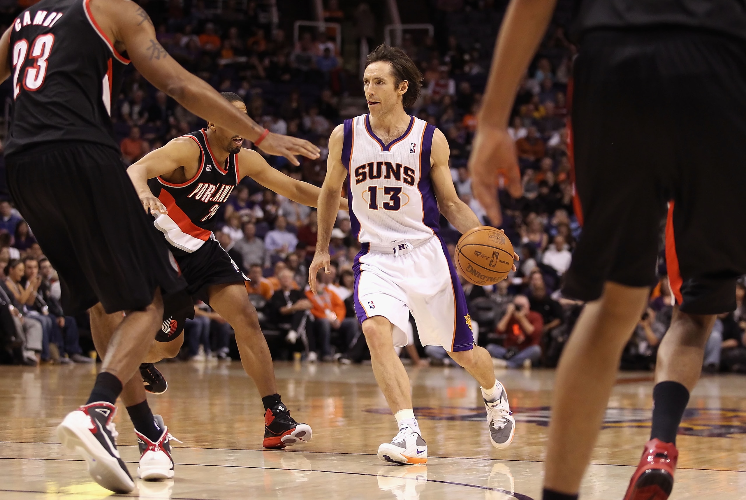 PHOENIX, AZ - JANUARY 14:  Steve Nash #13 of the Phoenix Suns handles the ball during the NBA game against the Portland Trail Blazers at US Airways Center on January 14, 2011 in Phoenix, Arizona. The Suns defeated the Trail Blazers 115-111. NOTE TO USER: