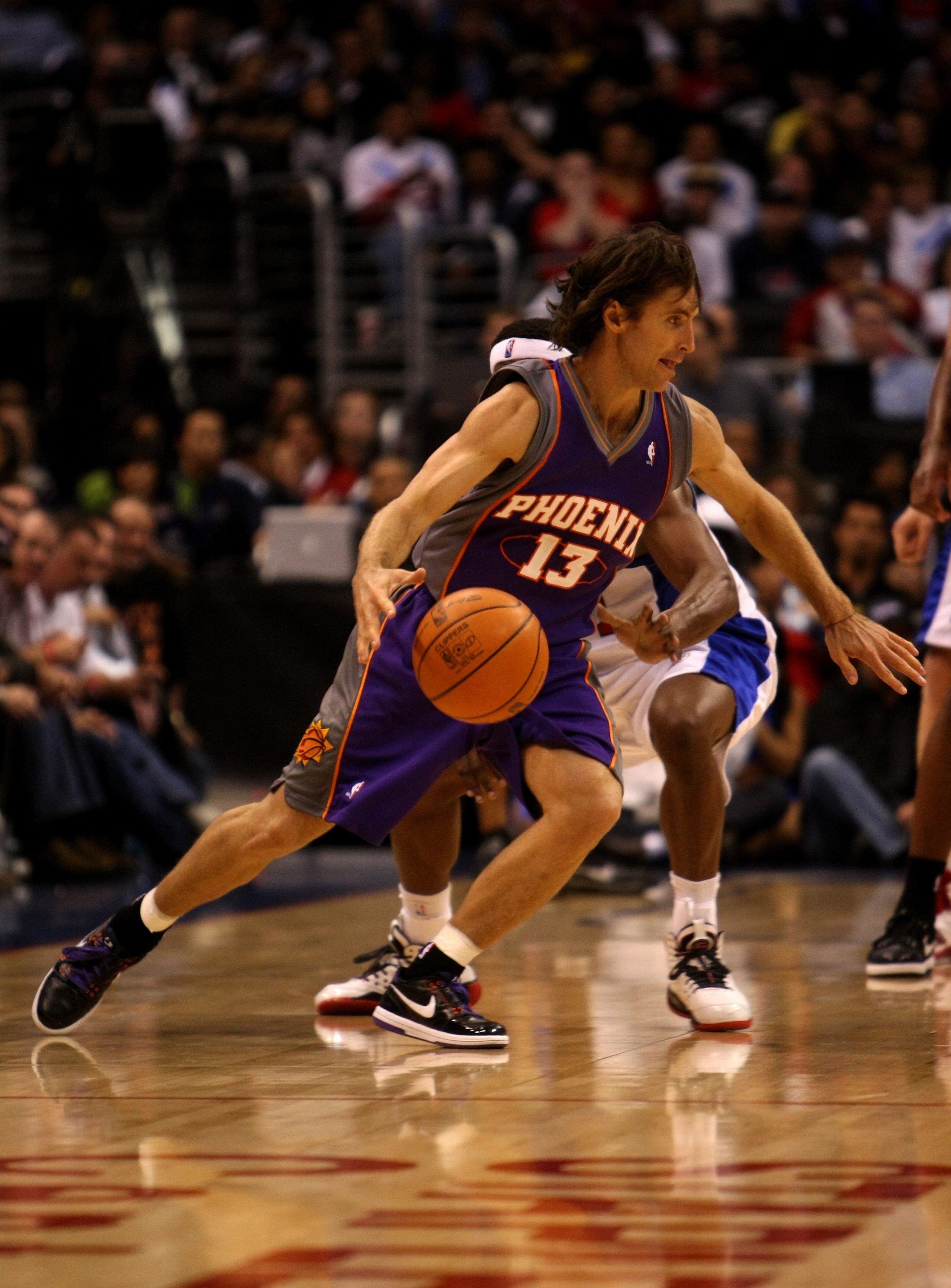 LOS ANGELES - OCTOBER 28: Steve Nash #13 of the Phoenix Suns drives around Baron Davis #1 of the Los Angeles Clippers on October 28, 2009 at Staples Center in Los Angeles, California. The Suns won 109-107.   NOTE TO USER: User expressly acknowledges and a