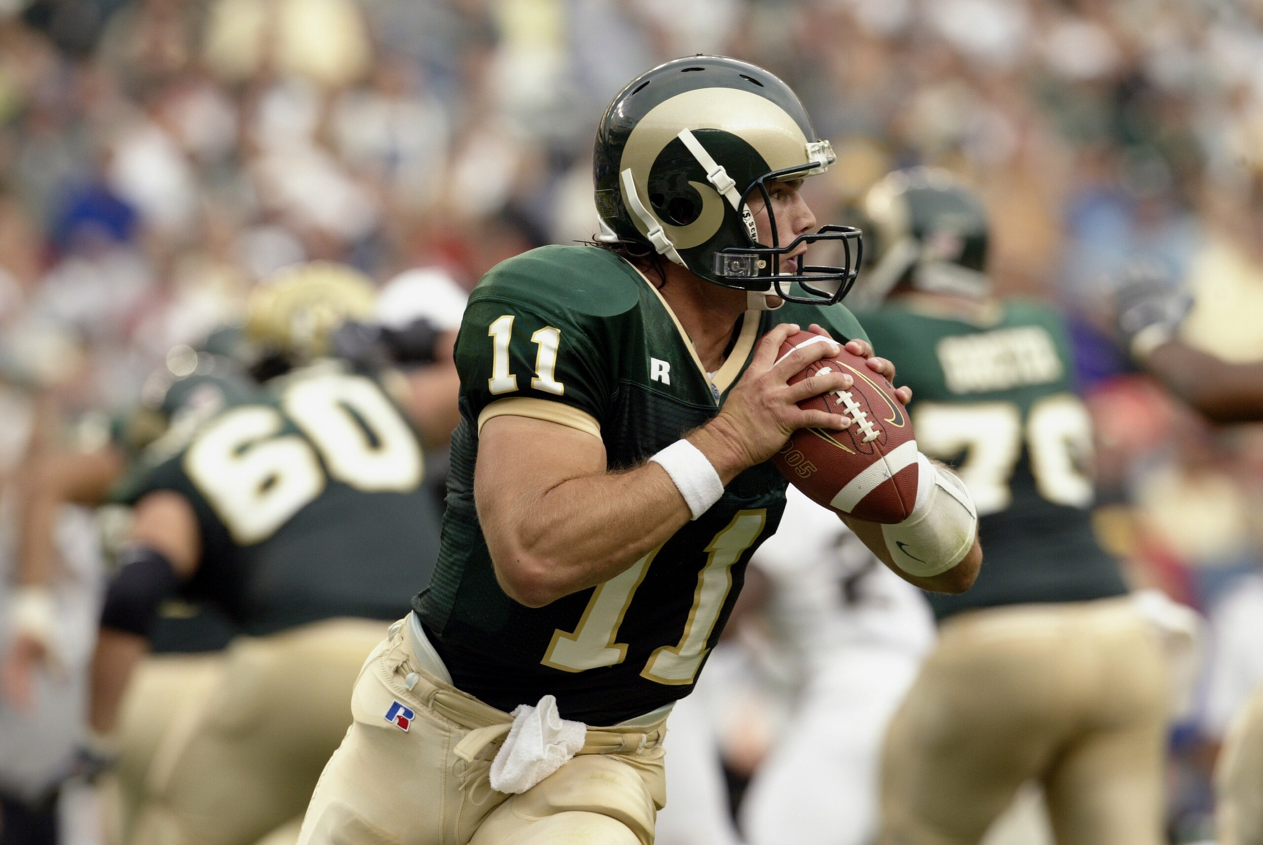 DENVER - AUGUST 30:  Quarterback Bradlee Van Pelt #11 of the Colorado State University Rams rolls out to throw a pass against the University of Colorado Buffaloes during the game at Invesco Field at Mile High on August 30, 2003 in Denver, Colorado. Colora