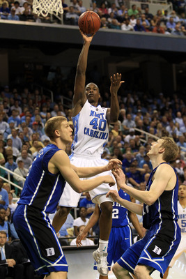 GREENSBORO, NC - MARCH 13:  Harrison Barnes #40 of the North Carolina Tar Heels shoots against Mason Plumlee #5 and Kyle Singler #12 of the Duke Blue Devils during the second half in the championship game of the 2011 ACC men's basketball tournament at the