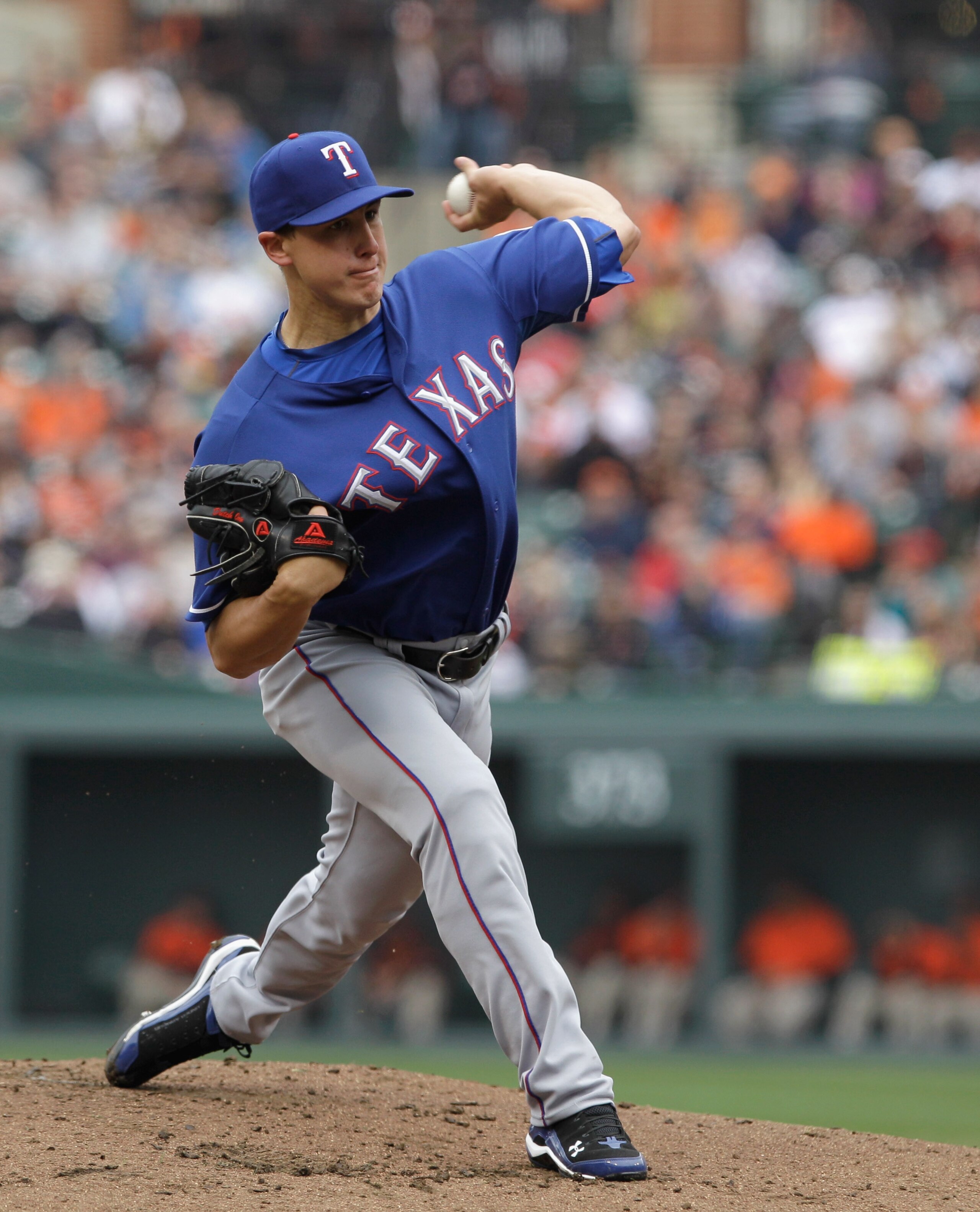 BALTIMORE, MD - APRIL 10:  Starting pitcher Derek Holland #45 of the Texas Rangers delivers to a Baltimore Orioles batter at Oriole Park at Camden Yards on April 10, 2011 in Baltimore, Maryland.  (Photo by Rob Carr/Getty Images)
