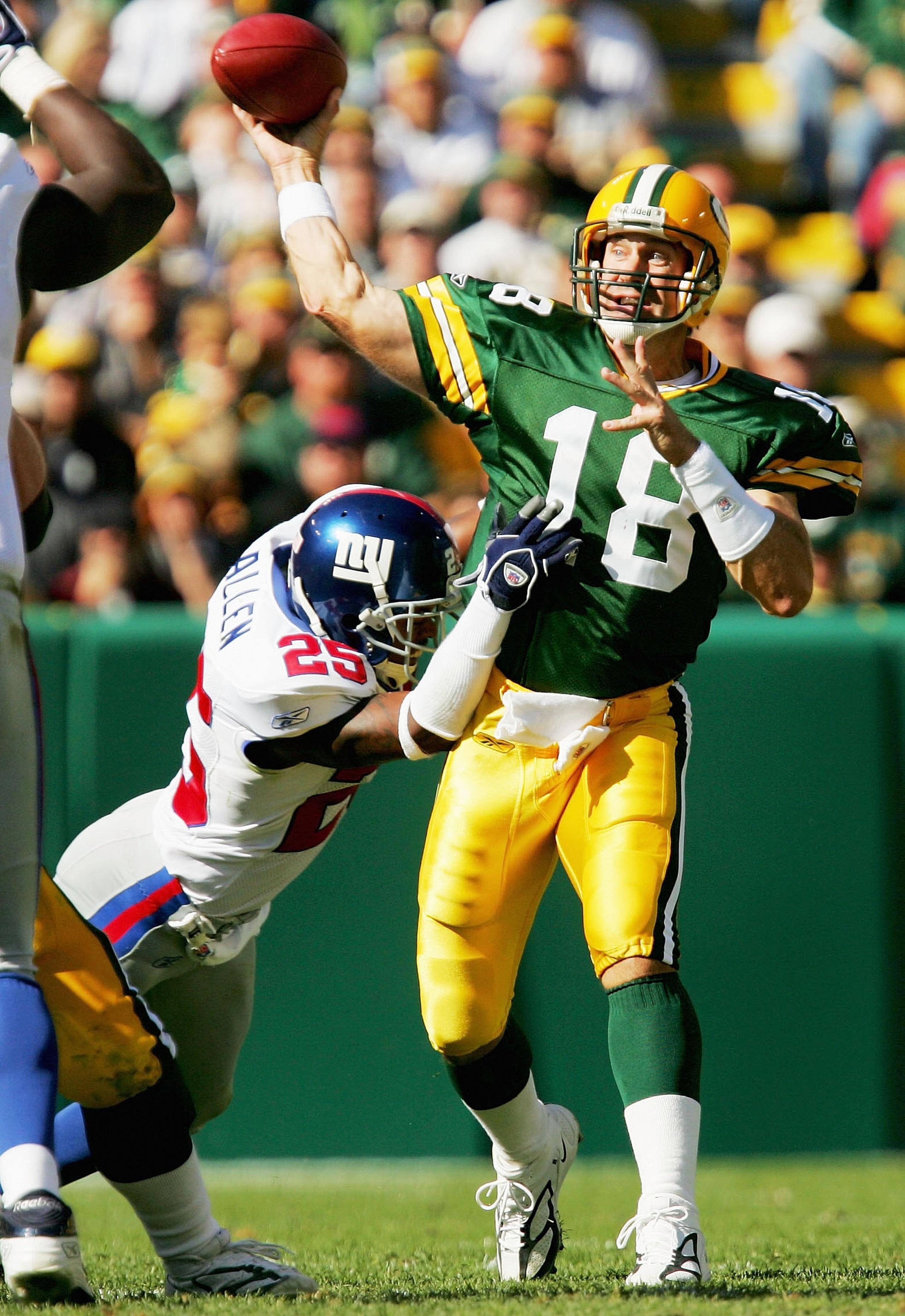 GREEN BAY, WI - OCTOBER 3:  Doug Pederson #18 of the Green Bay Packers throws under pressure by Will Allen #25 of the New York Giants October 3, 2004 at Lambeau Field in Green Bay, Wisconsin. The Giants defeated the Packers 14-7.  (Photo by Matthew Stockm