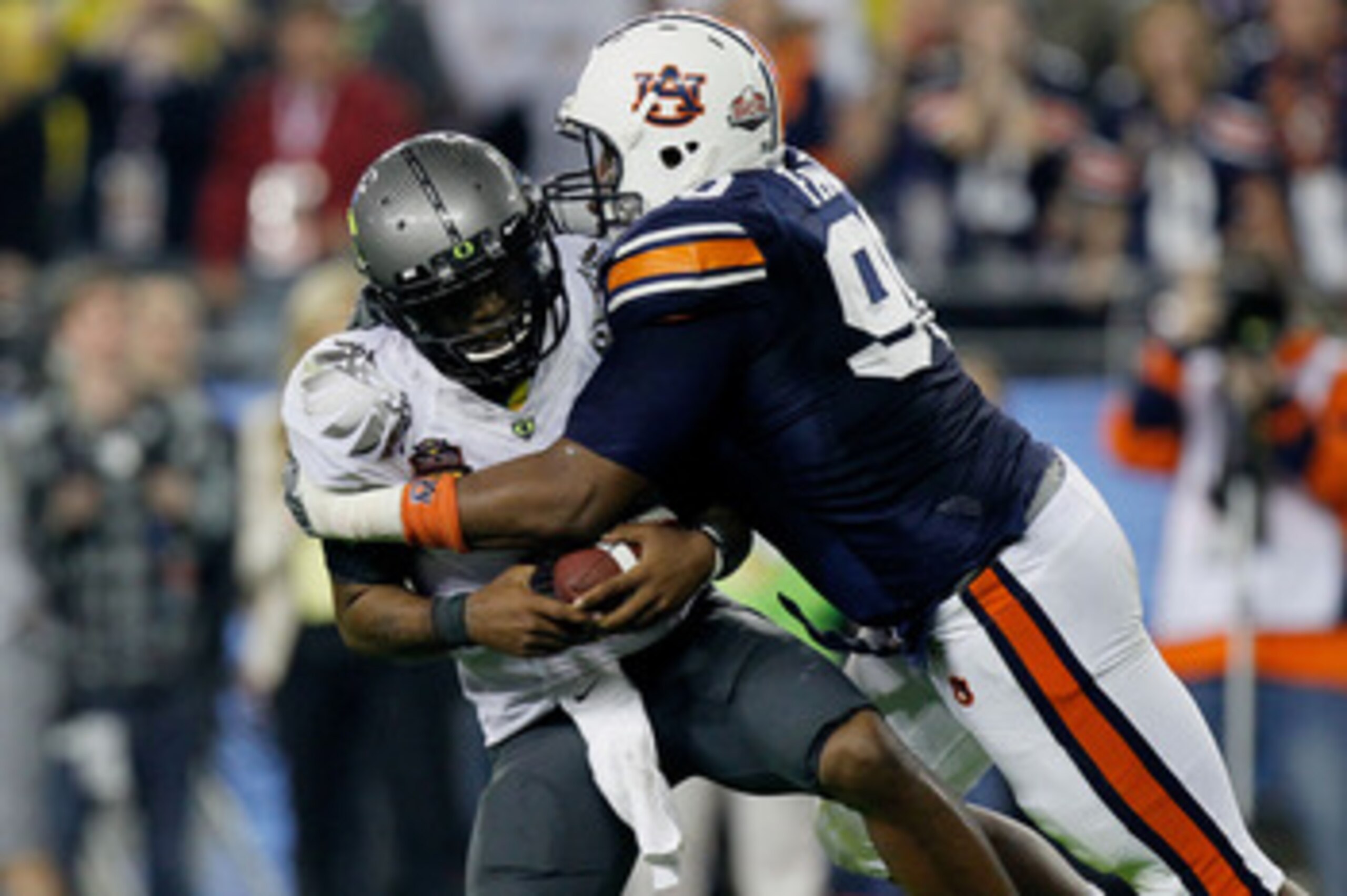 GLENDALE, AZ - JANUARY 10: Quarterback Darron Thomas #1 of the Oregon Ducks is sacked by Nick Fairley #90 of the Auburn Tigers in the first half in the Tostitos BCS National Championship Game at University of Phoenix Stadium on January 10, 2011 in Glenda GLENDALE, AZ - JANUARY 10: Quarterback Darron Thomas #1 of the Oregon Ducks is sacked by Nick Fairley #90 of the Auburn Tigers in the first half in the Tostitos BCS National Championship Game at University of Phoenix Stadium on January 10, 2011 in Glenda