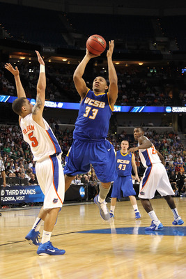 TAMPA, FL - MARCH 17:  Orlando Johnson #33 of the UC Santa Barbara Gauchos drives for a shot attempt against Scottie Wilbekin #5 of the Florida Gators during the second round of the 2011 NCAA men's basketball tournament at St. Pete Times Forum on March 17