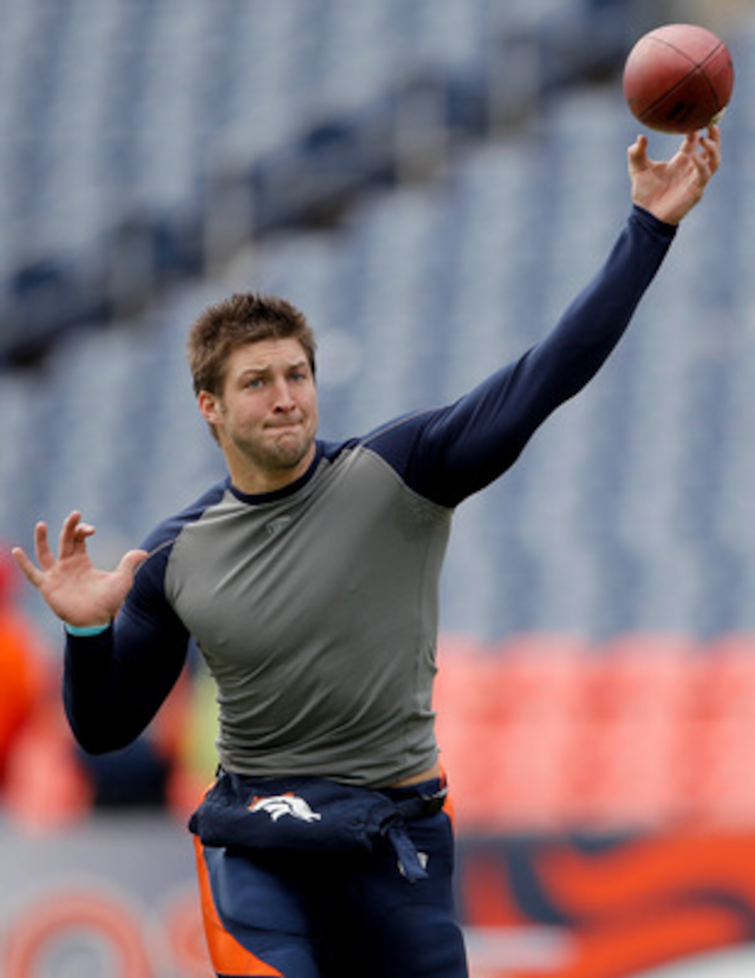 DENVER - JANUARY 2:  Quarterback Tim Tebow #15 of the Denver Broncos warms up before a game against the San Diego Chargers at INVESCO Field at Mile High on January 2, 2011 in Denver, Colorado. (Photo by Justin Edmonds/Getty Images)