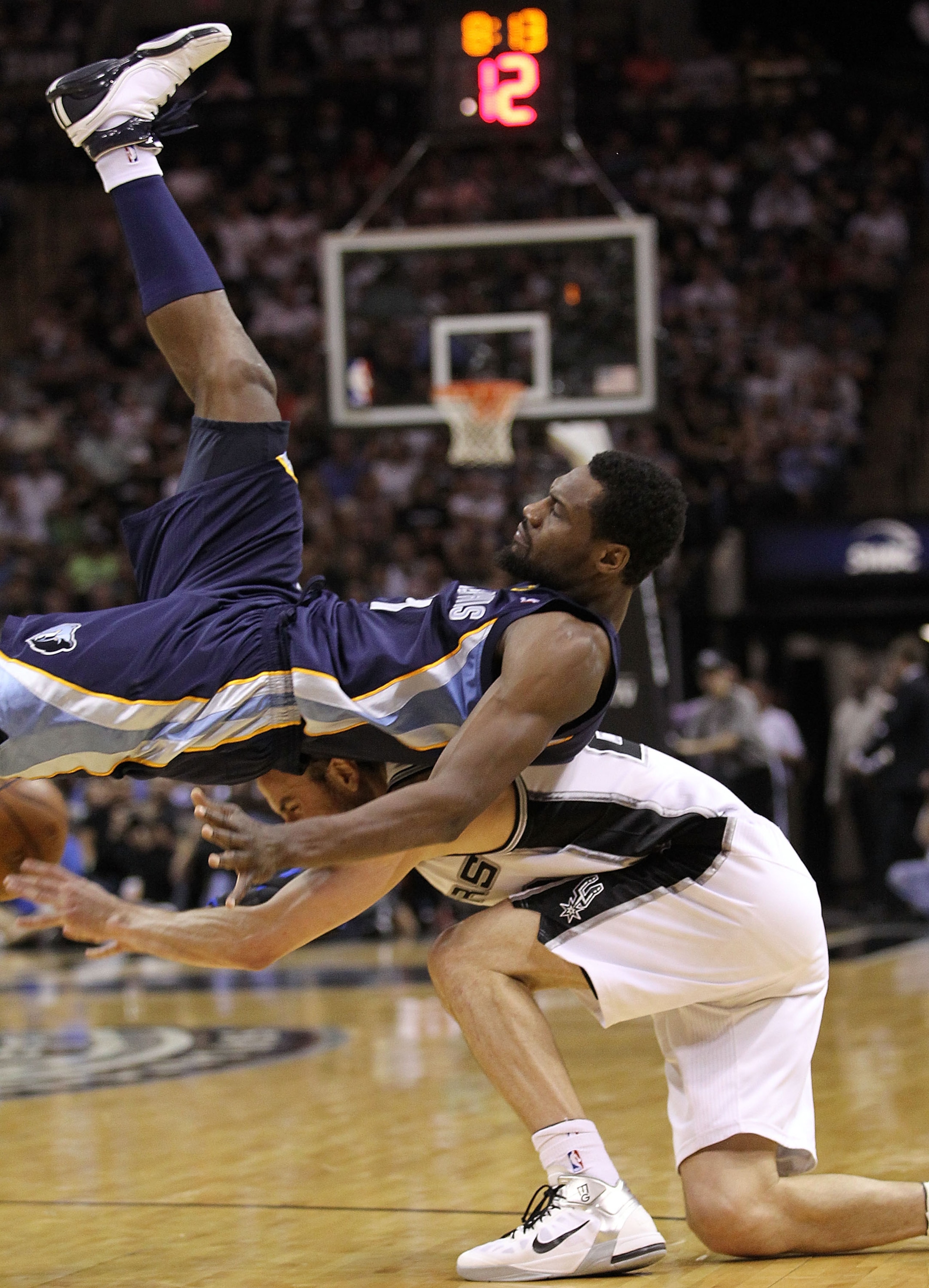 SAN ANTONIO, TX - APRIL 20:  Guard Tony Allen #9 of the Memphis Grizzlies falls on top of Manu Ginobili #20 of the San Antonio Spurs in Game Two of the Western Conference Quarterfinals in the 2011 NBA Playoffs on April 20, 2011 at AT&T Center in San Anton