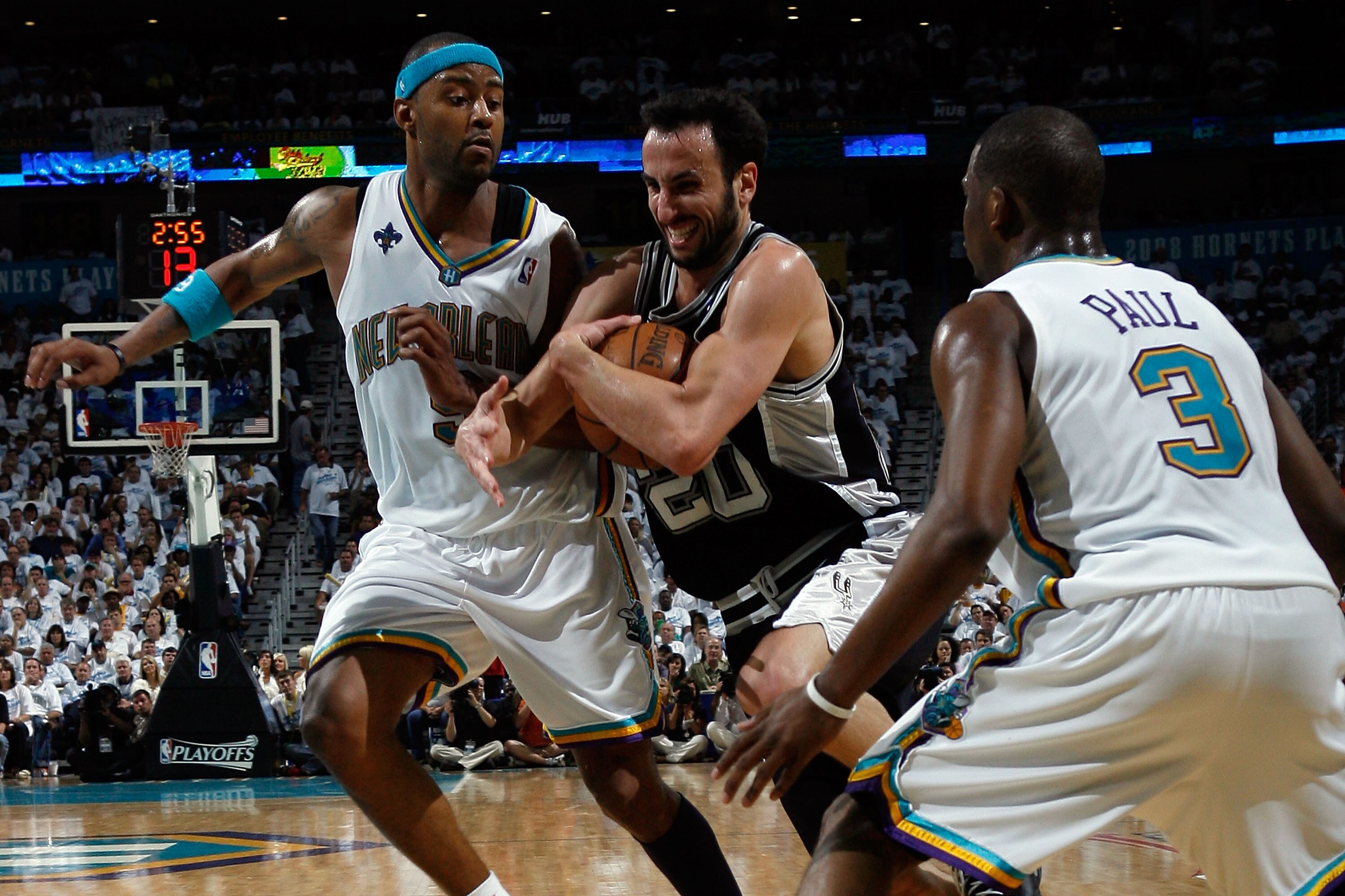 NEW ORLEANS - MAY 19:  Manu Ginobili #20 of the San Antonio Spurs drives the ball around Morris Peterson #9 of the New Orleans Hornets in Game Seven of the Western Conference Semifinals during the 2008 NBA Playoffs at The New Orleans Arena on May 19, 2008