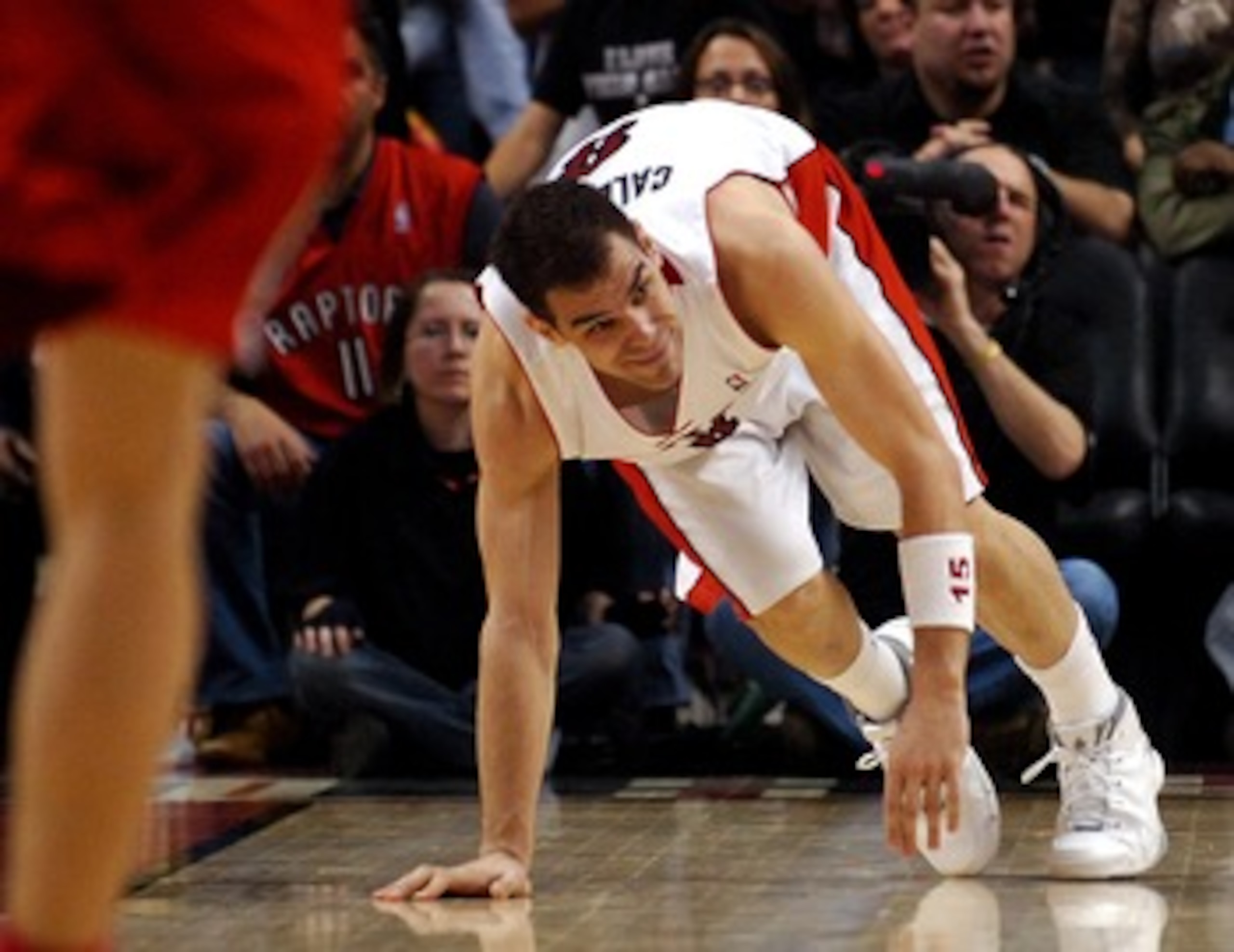 TORONTO- MAY 1:  Jose Calderon #8 of the Toronto Raptors goes down with an ankle injury late in Game Five of the Eastern Conference Quarterfinals during the 2007 NBA Playoffs at Air Canada Centre on May 1, 2007 in Toronto, Ontario, Canada . Raptors win 98