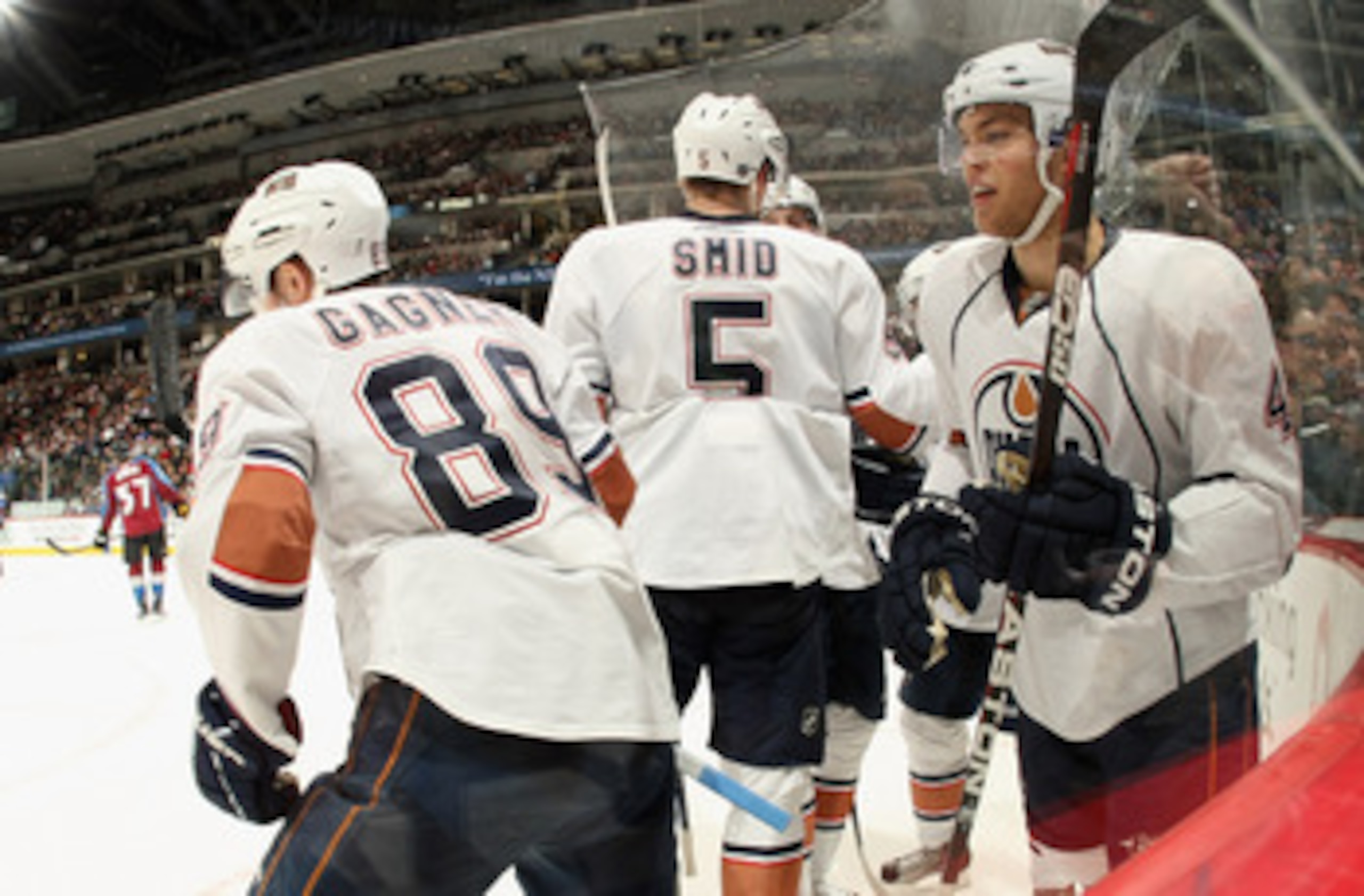 DENVER, CO - FEBRUARY 23:  Taylor Hall #4 of the Edmonton Oilers celebrates his second period goal against the Colorado Avalanche with Sam Gagner #89 and Ladislav Smid #5 of the Oilers at the Pepsi Center on February 23, 2011 in Denver, Colorado.  (Photo