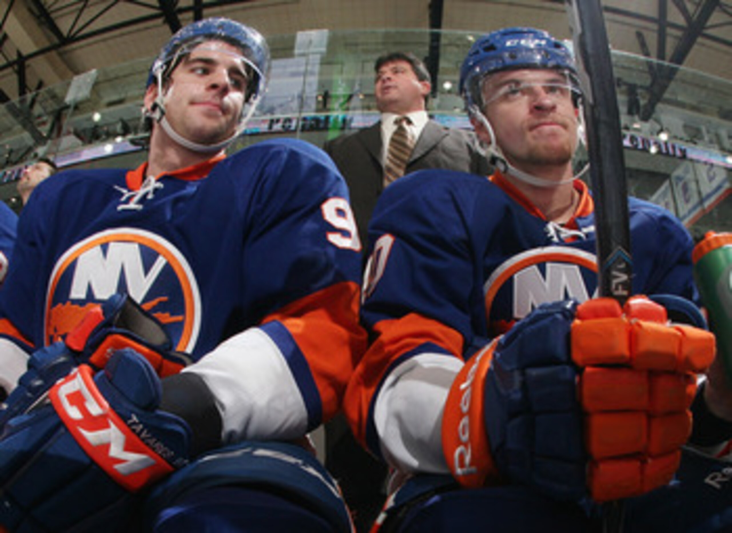 UNIONDALE, NY - DECEMBER 29: (L-R) John Tavares #91 and Michael Grabner #40 of the New York Islanders sit on the bench as head coach Jack Capuano watches the action against the Pittsburgh Penguins at the Nassau Coliseum on December 29, 2010 in Uniondale,