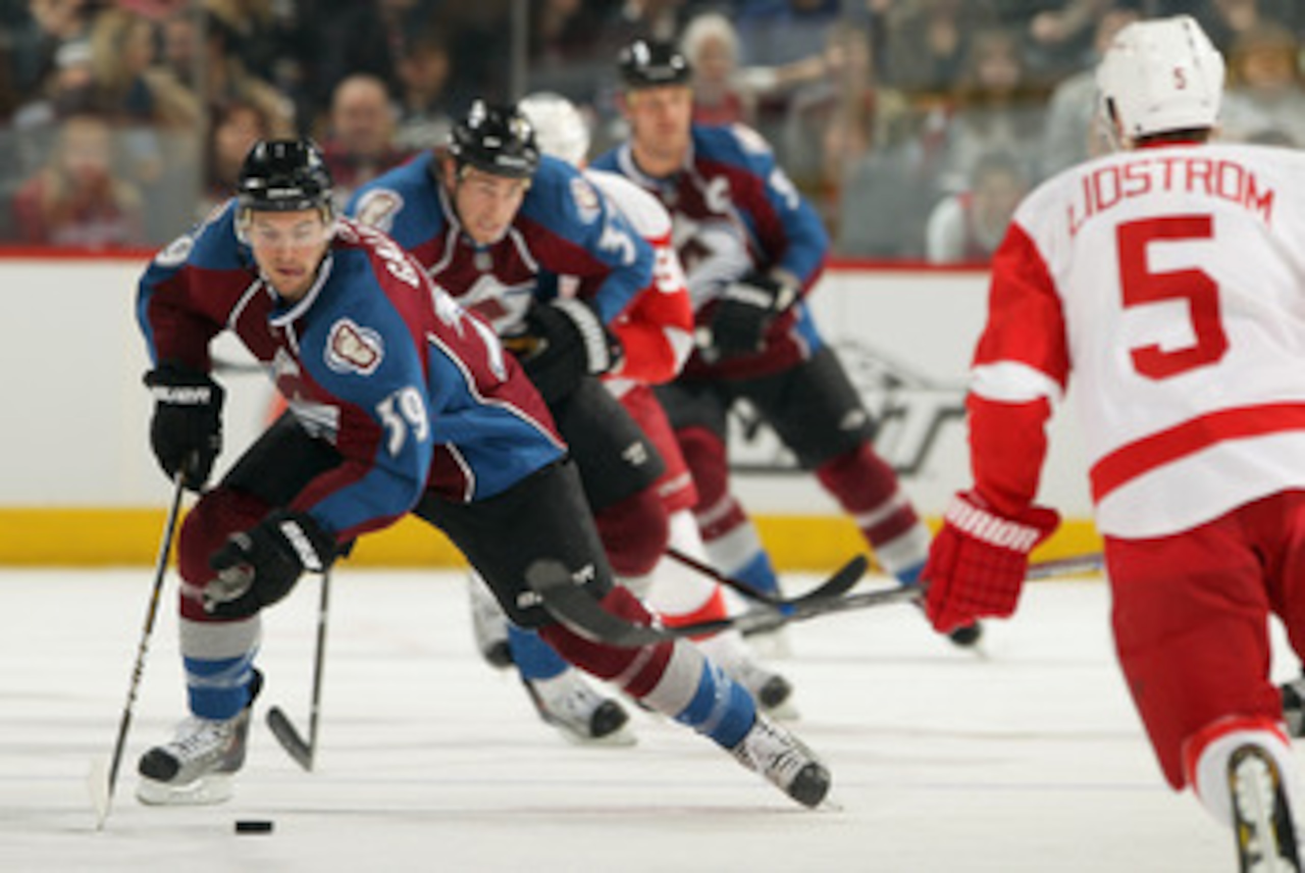 DENVER, CO - JANUARY 10:  TJ Galiardi #39 of the Colorado Avalanche controls the puck against Nicklas Lidstrom #5 of the Detroit Red Wings at the Pepsi Center on January 10, 2011 in Denver, Colorado. The Avalanche defeated the Red Wings 5-4.  (Photo by Do