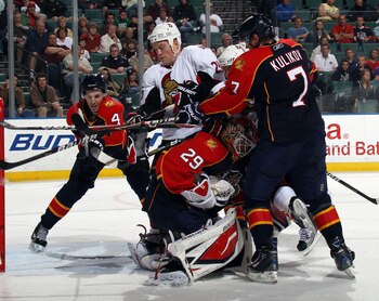 SUNRISE, FL - MARCH 10: Keaton Ellerby #4, Dmitry Kulikov #7 and Tomas Vokoun #29 of the Florida Panthers defend the net against Chris Neil #25 of the Ottawa Senators at the BankAtlantic Center on March 10, 2011 in Sunrise, Florida. The Senators defeated