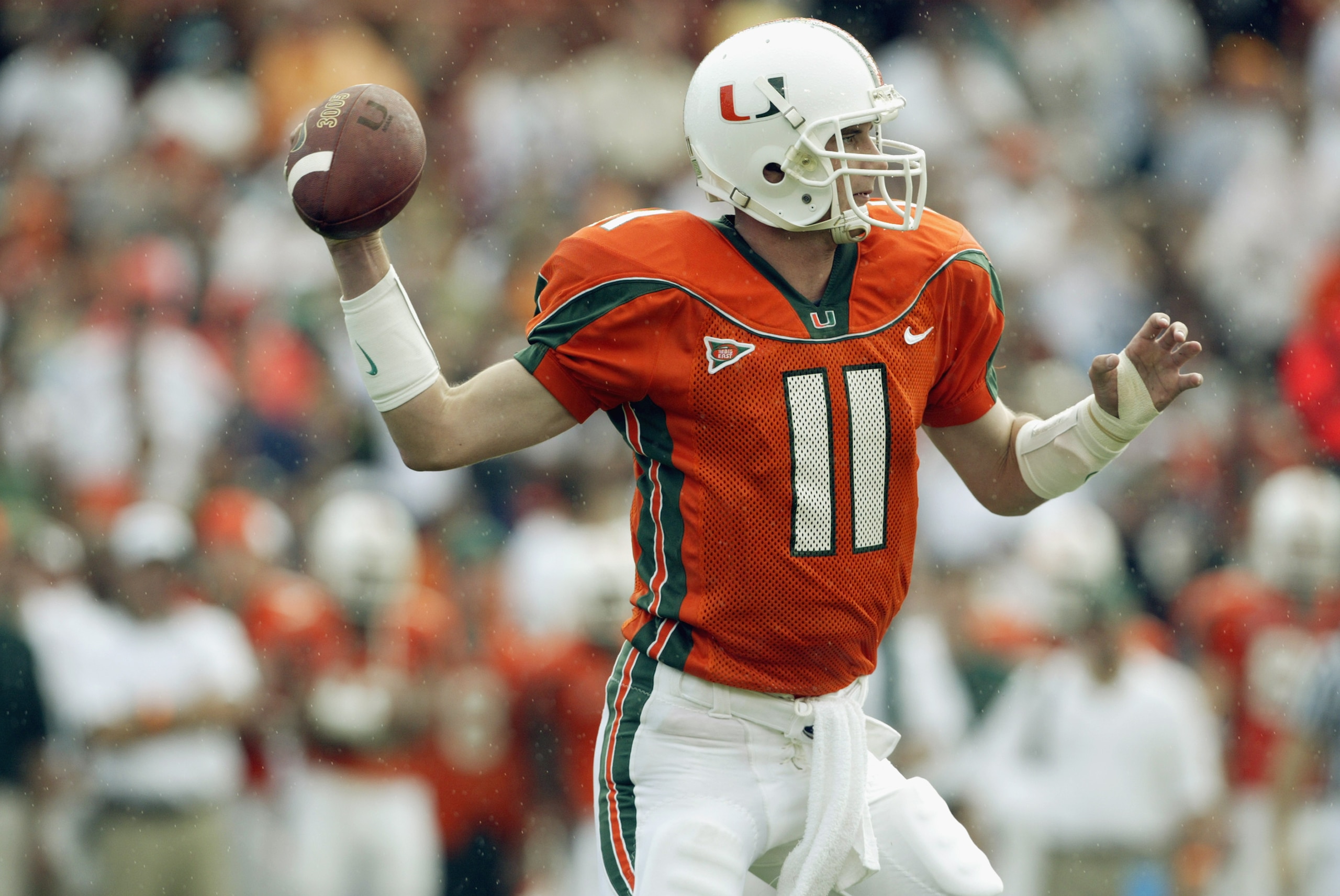 MIAMI - DECEMBER 7:  Quarterback Ken Dorsey #11 of the University of Miami Hurricanes attempts to pass the ball against the Virginia Polytechnic Institute and State University Hokies during the game at the Orange Bowl on December 7, 2002 in Miami, Florida