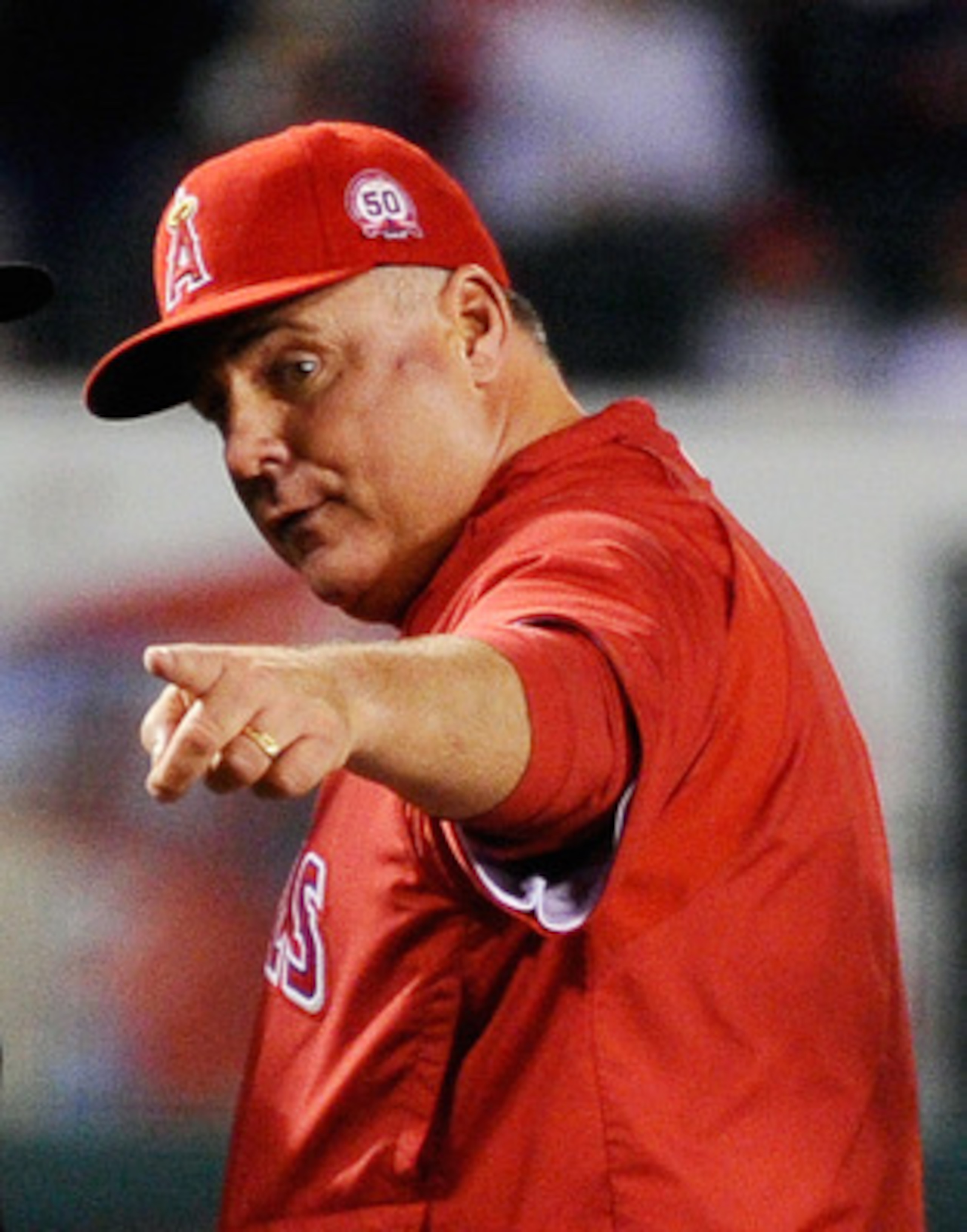 ANAHEIM, CA - APRIL 21:  Manager Mike Scioscia #14 argues with third base umpire Dan Bellino #33 after Dustin Pedroia #15 of the Boston Red Sox was called safe after a run down between third base and home plate during the 11th inning of the baseball game