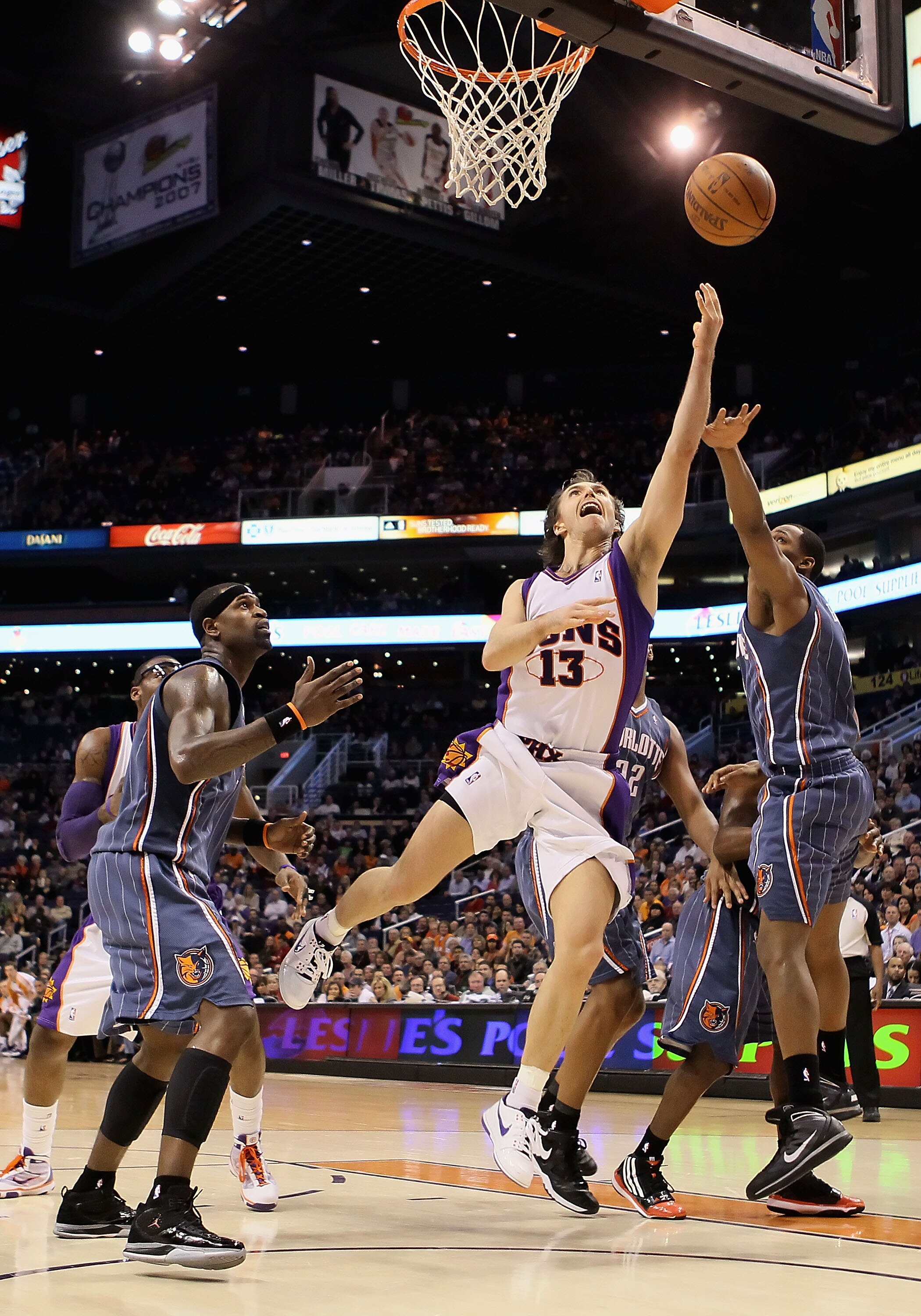 PHOENIX - JANUARY 26:  Steve Nash #13 of the Phoenix Suns lays up a shot against the Charlotte Bobcats during the NBA game at US Airways Center on January 26, 2010 in Phoenix, Arizona. The Bobcats defeated the Suns in overtime 114-109.  NOTE TO USER: User