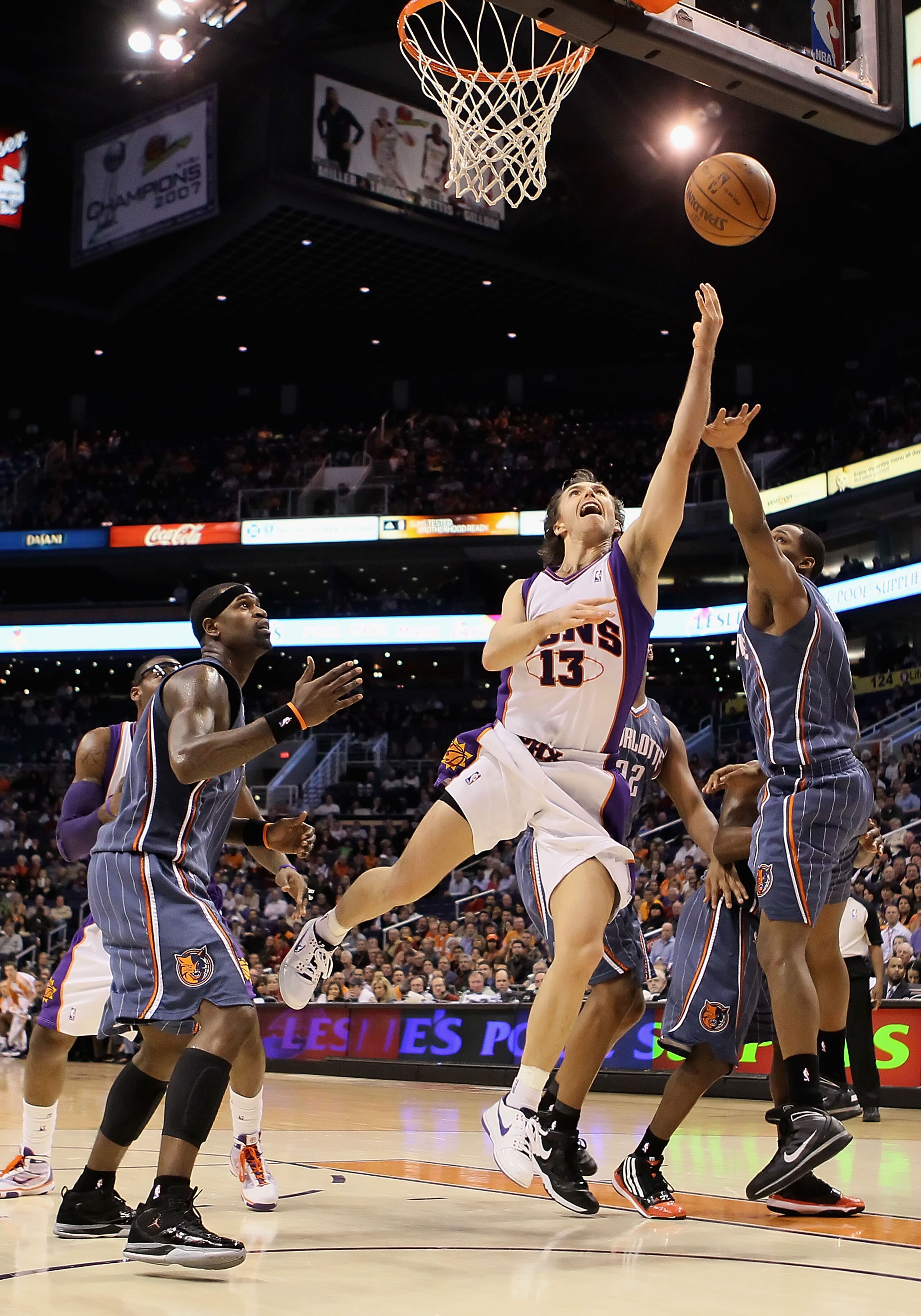 PHOENIX - JANUARY 26:  Steve Nash #13 of the Phoenix Suns lays up a shot against the Charlotte Bobcats during the NBA game at US Airways Center on January 26, 2010 in Phoenix, Arizona. The Bobcats defeated the Suns in overtime 114-109.  NOTE TO USER: User