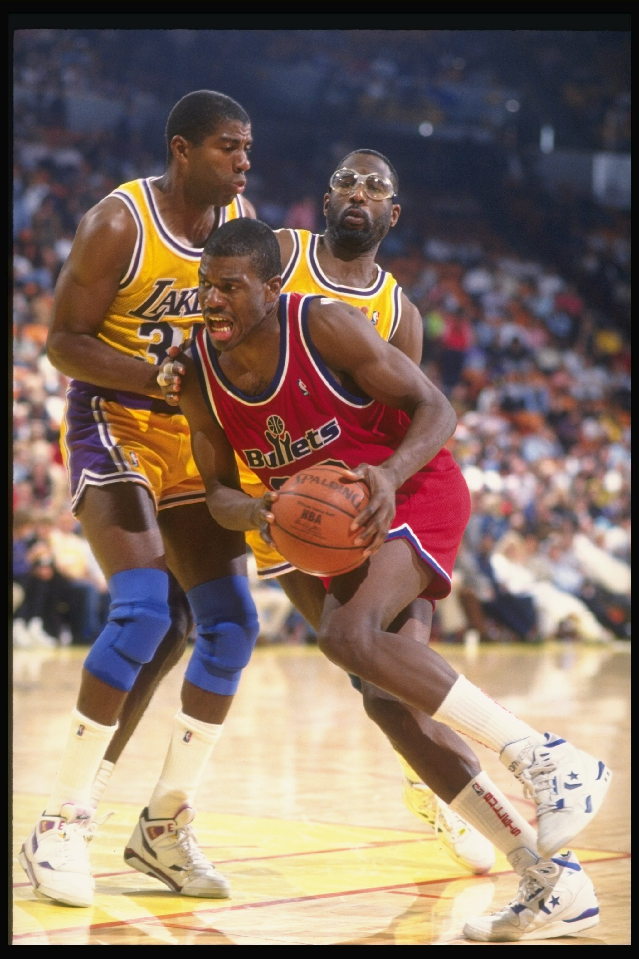 8 Dec 1990:  Forward Bernard King of the Washington Bullets (center) drives the ball past guard Magic Johnson (left) and forward James Worthy of the Los Angeles Lakers during a game at the Great Western Forum in Inglewood, California. Mandatory Credit: Ke