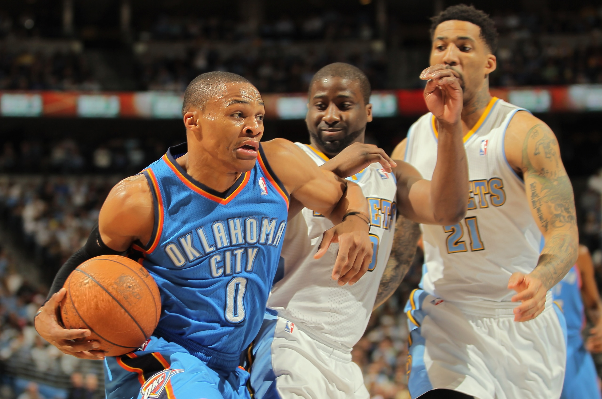 DENVER, CO - APRIL 23:  Russell Westbrook #0 of the Oklahoma City Thunder drives to the basket against Raymond Felton #20 and Wilson Chandler #21 of the Denver Nuggets in Game Three of the Western Conference Quarterfinals in the 2011 NBA Playoffs on April
