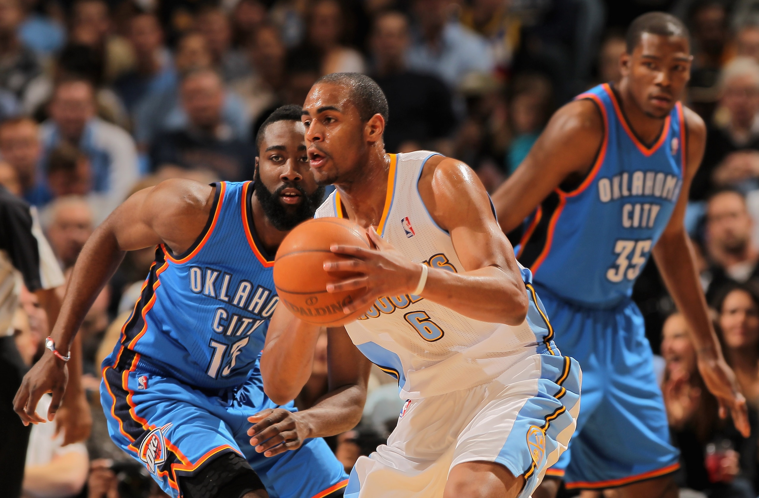 DENVER, CO - APRIL 23:  Arron Afflalo #6 of the Denver Nuggets controls the ball against James Harden #13 and Kevin Durant #35 of the Oklahoma City Thunder in Game Three of the Western Conference Quarterfinals in the 2011 NBA Playoffs on April 23, 2011 at