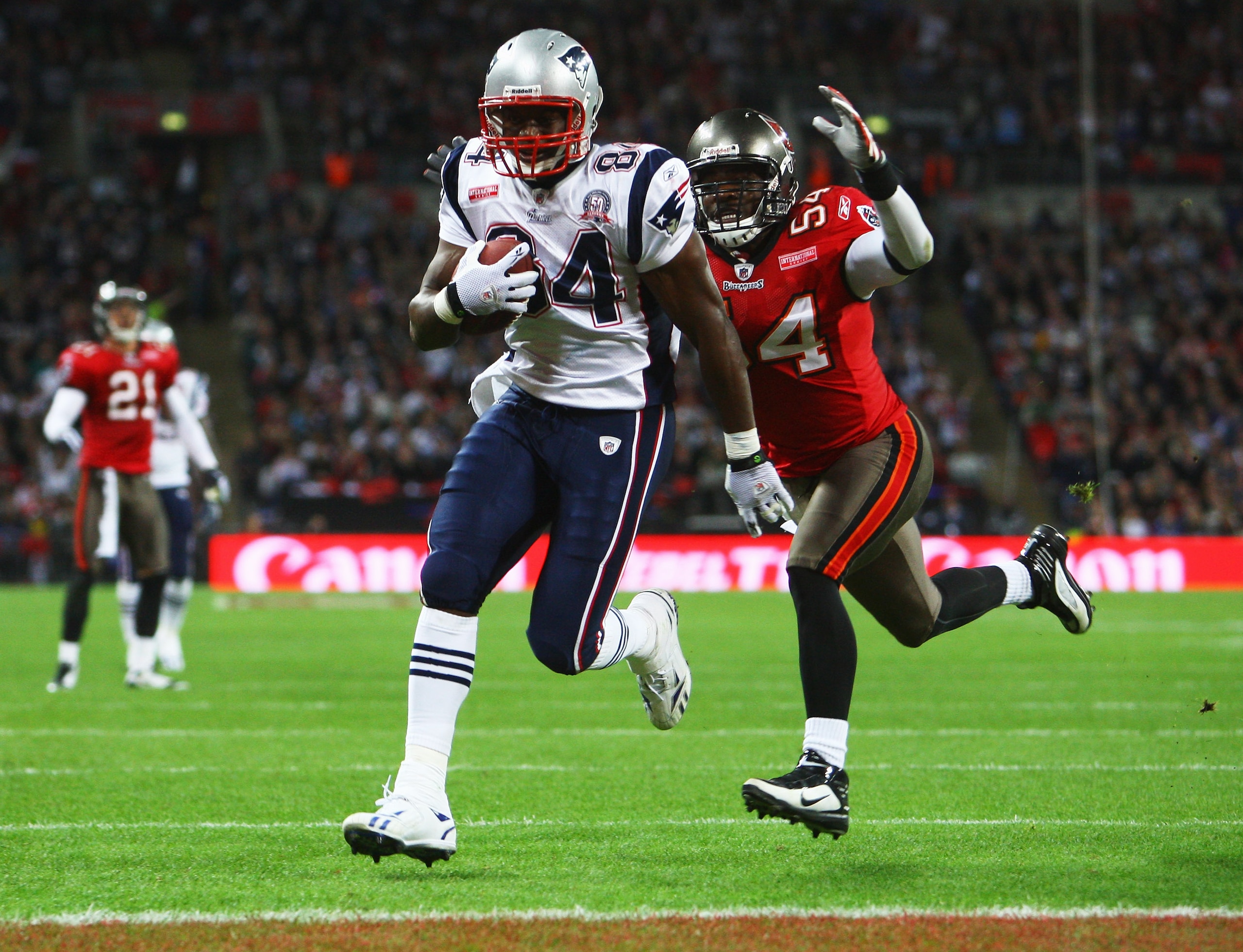 LONDON, ENGLAND - OCTOBER 25:  Benjamin Watson (#84) of the New England Patriots runs with the ball chased by Geno Hayes  (#54) of Tampa Bay Buccaneer during the NFL International Series match between New England Patriots and Tampa Bay Buccaneers at Wembl