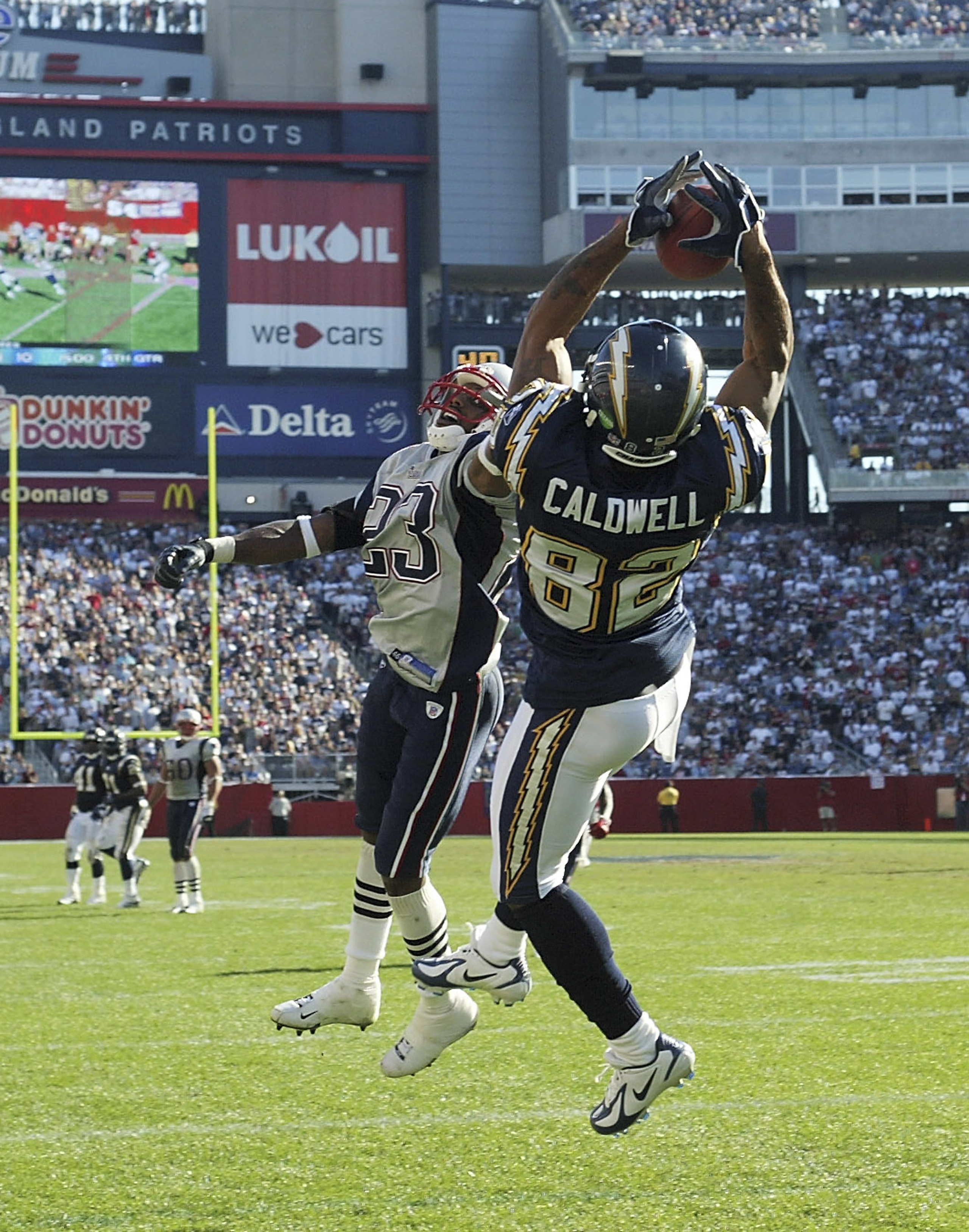 FOXBORO, MA - OCTOBER 2:  Wide receiver Reche Caldwell #82 of the San Diego Chargers catches a 28-yard touchdown pass against cornerback Duane Starks #23 of the New England Patriots in the third quarter on October 2, 2005 at Gillette Stadium in Foxboro, M