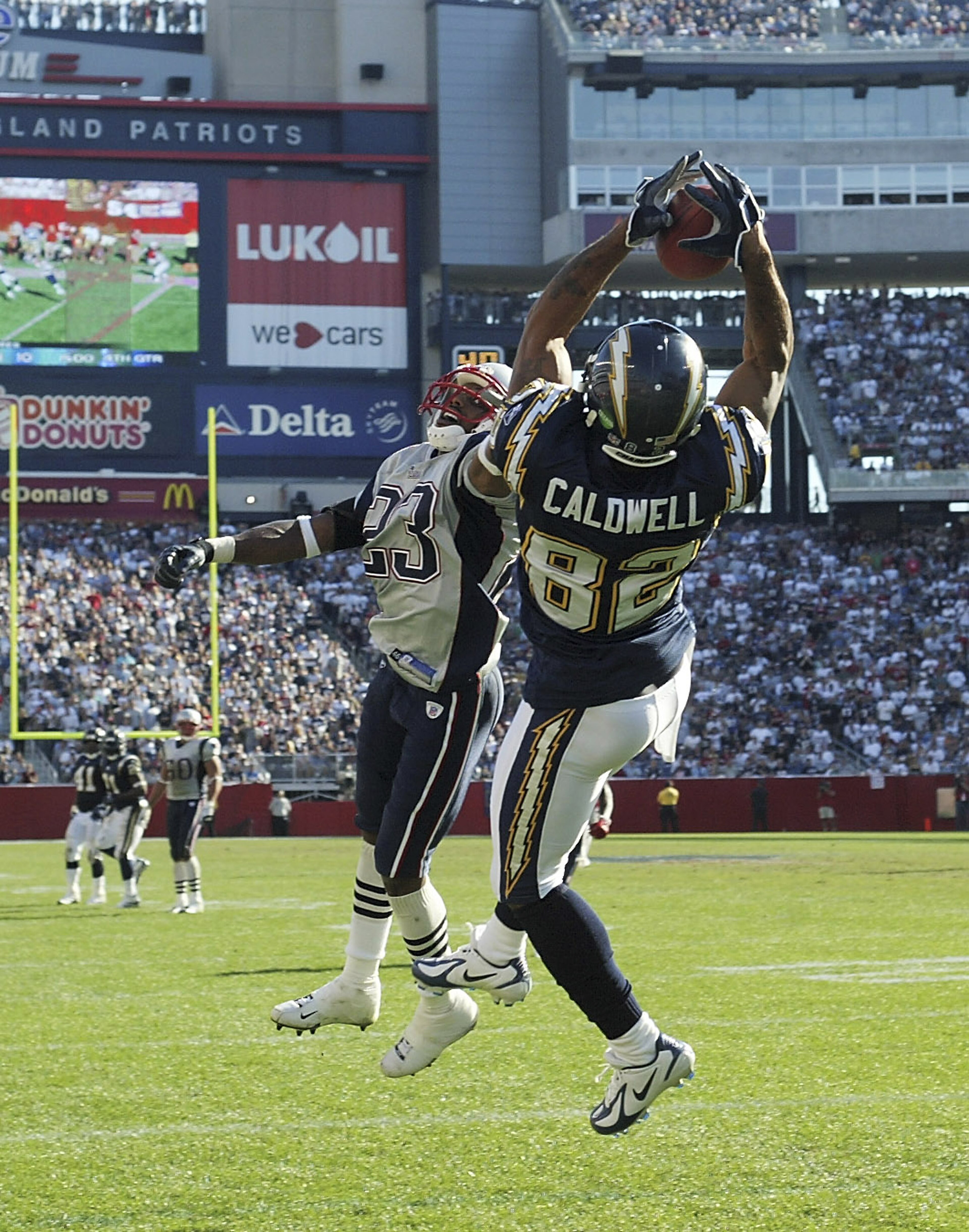 FOXBORO, MA - OCTOBER 2:  Wide receiver Reche Caldwell #82 of the San Diego Chargers catches a 28-yard touchdown pass against cornerback Duane Starks #23 of the New England Patriots in the third quarter on October 2, 2005 at Gillette Stadium in Foxboro, M