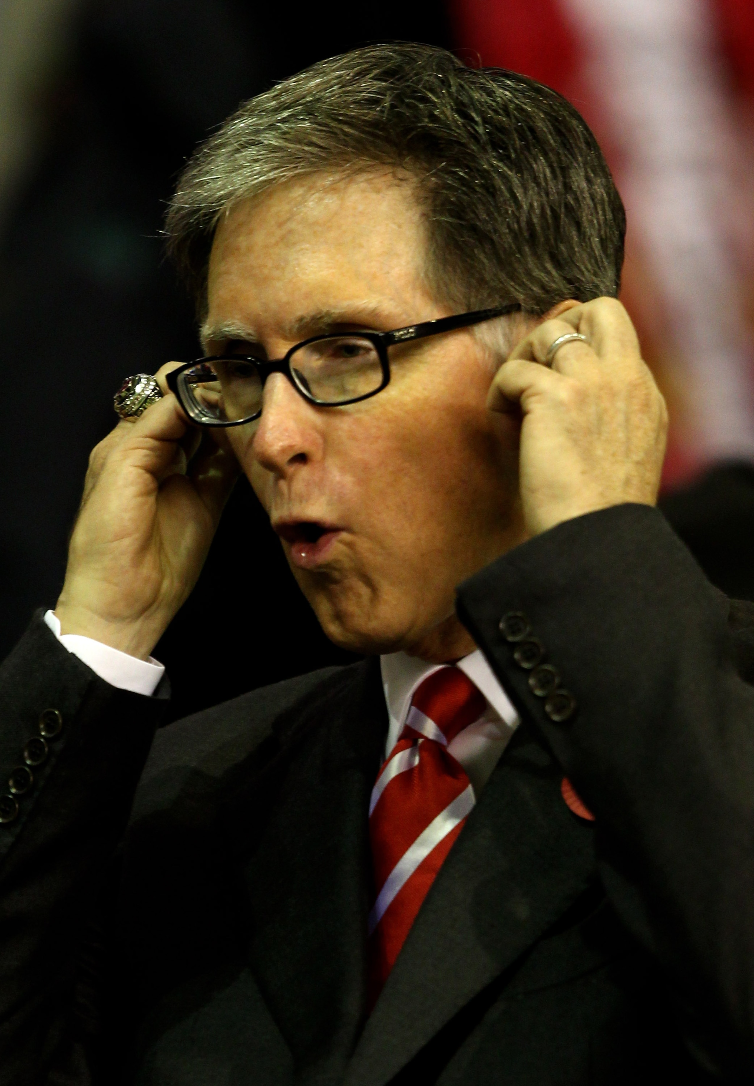 LIVERPOOL, ENGLAND - NOVEMBER 04:  Liverpool Owner John Henry puts his fingers in his ears prior to the UEFA Europa League Group K match beteween Liverpool and SSC Napoli at Anfield on November 4, 2010 in Liverpool, England.  (Photo by Clive Brunskill/Get
