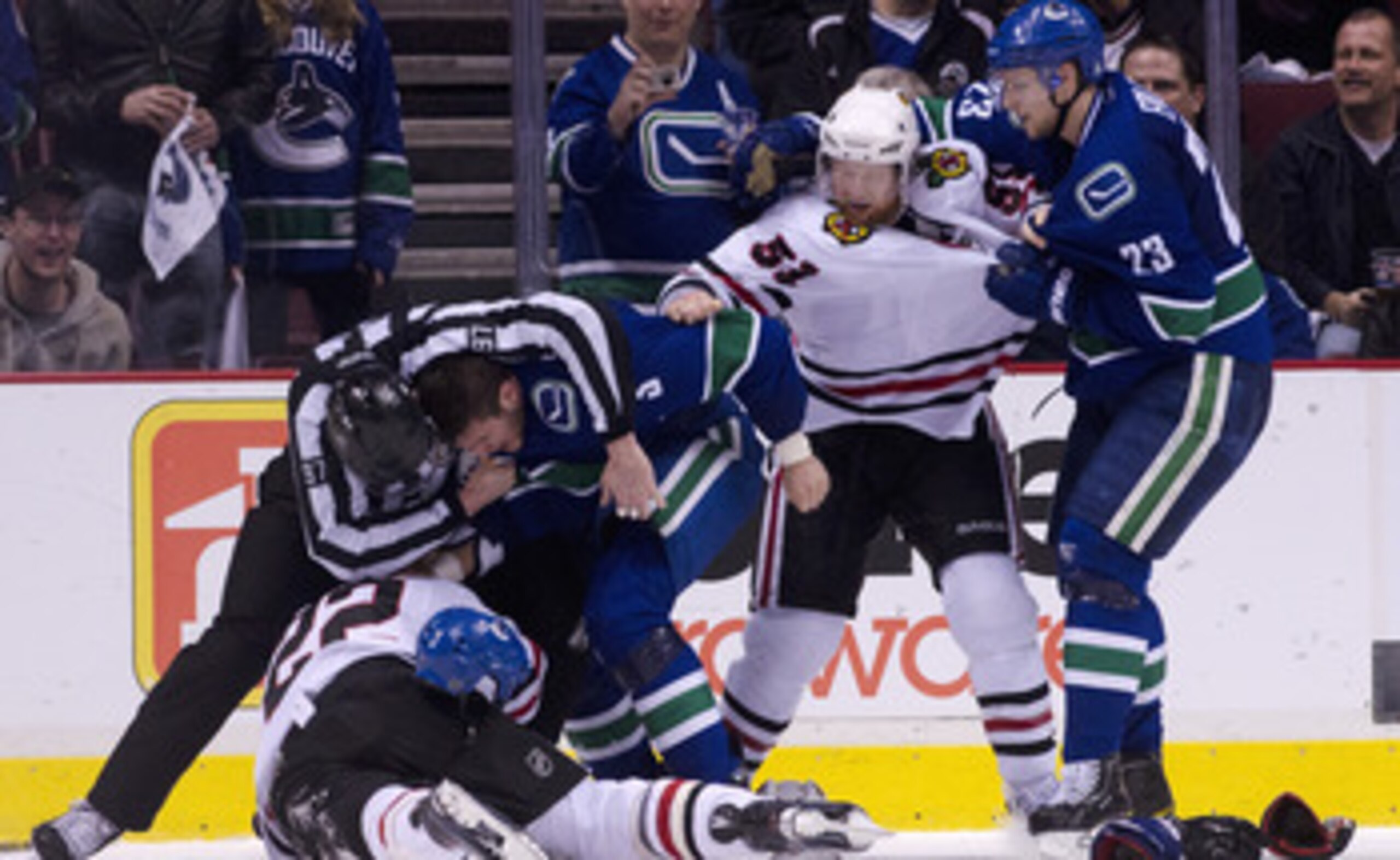VANCOUVER, CANADA - APRIL 21: Linesman Jean Morin #97 tries to separate Kevin Bieksa #3 of the Vancouver Canucks and Troy Brouwer #22 of the Chicago Blackhawks while Alexander Edler #23 of the Vancouver Canucks  and Brian Campbell #51 of the Chicago Black