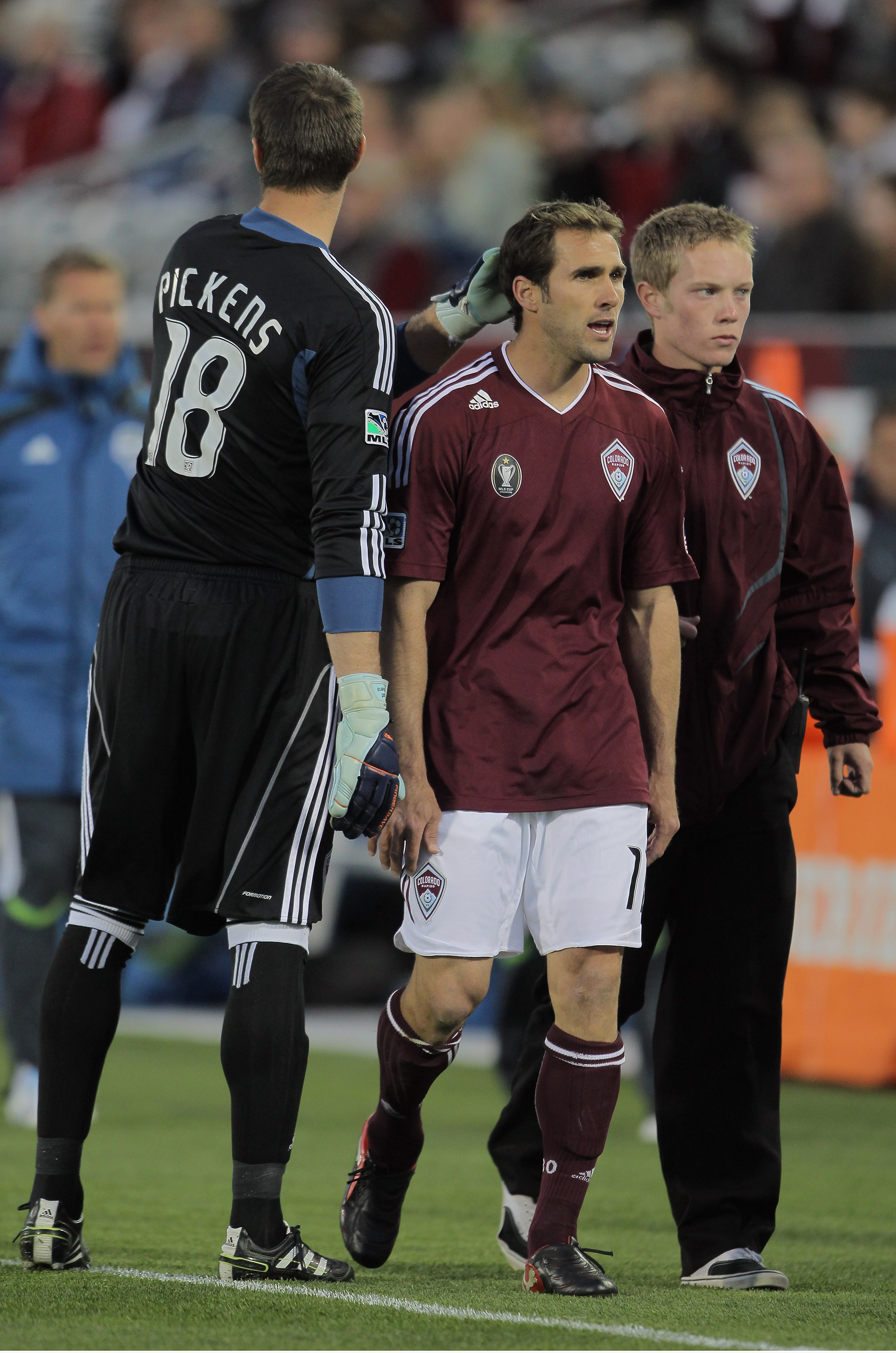 COMMERCE CITY, CO - APRIL 22: Brian Mullan #11 of the Colorado Rapids recieves a pat from goalkeeper Matt Pickens #18 of the Colorado Rapids as he leaves the field after a red card foul on Steve Zakuani #11 of the Seattle Sounders FC in the third minute