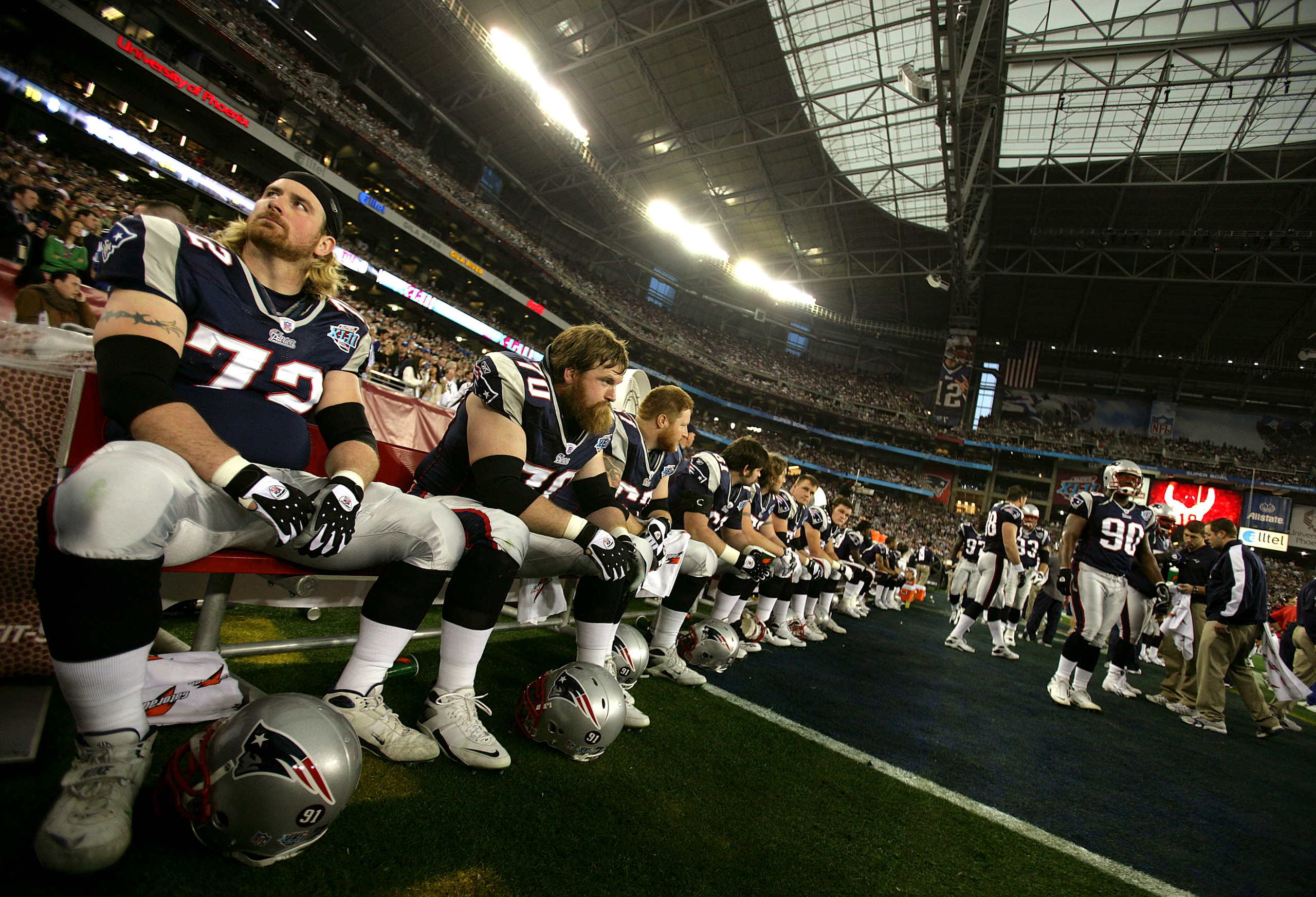 GLENDALE, AZ - FEBRUARY 03:  Matt Light #72 (L) and Logan Mankins #70 of the New England Patriots wait on the bench minutes before kick-off against the New York Giants in Super Bowl XLII on February 3, 2008 at the University of Phoenix Stadium in Glendale